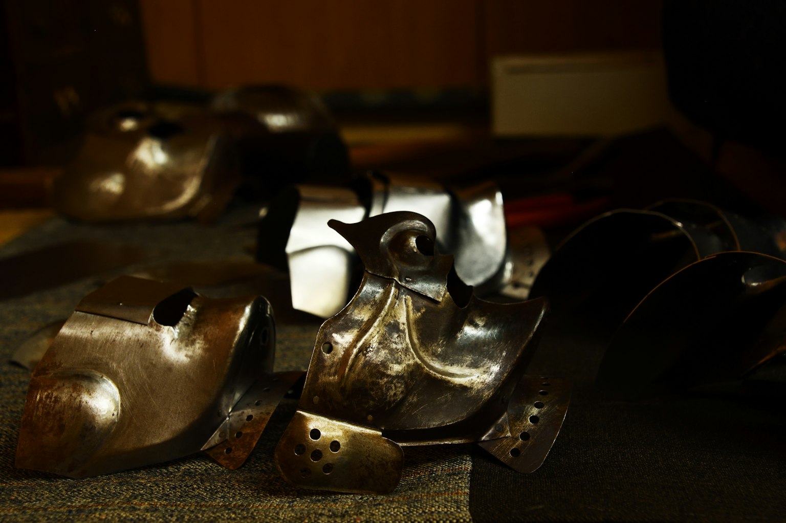 Image of scattered metal armor pieces on the floor