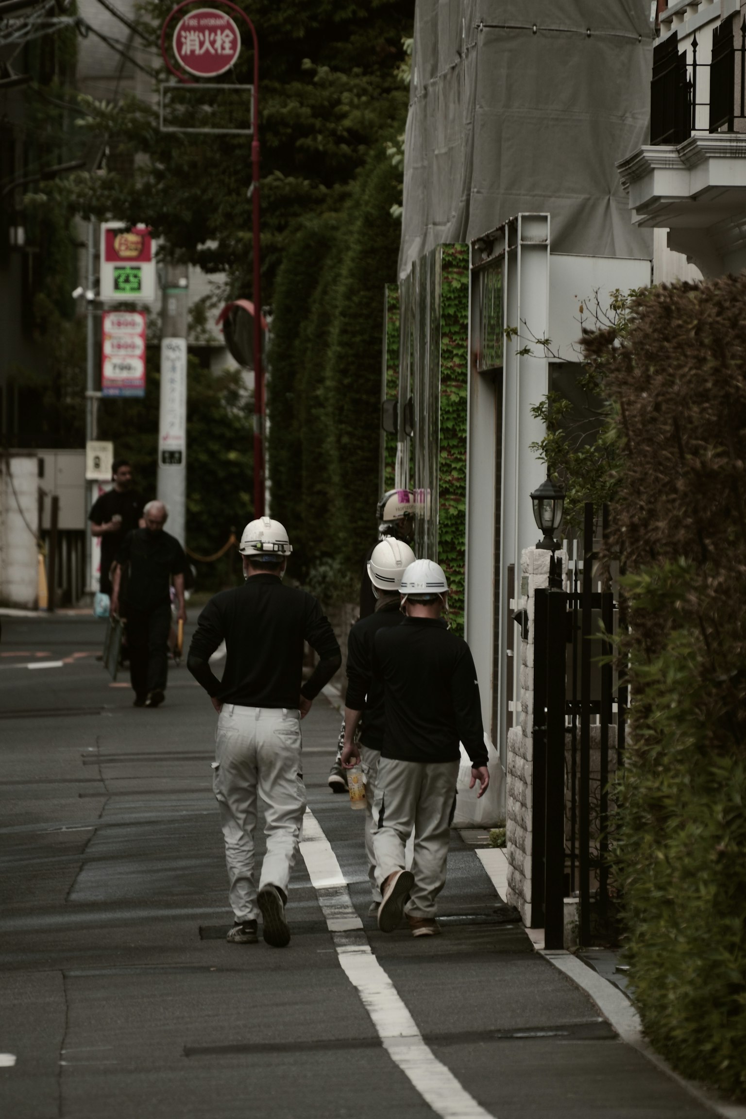 Workers in uniforms walking down a city street