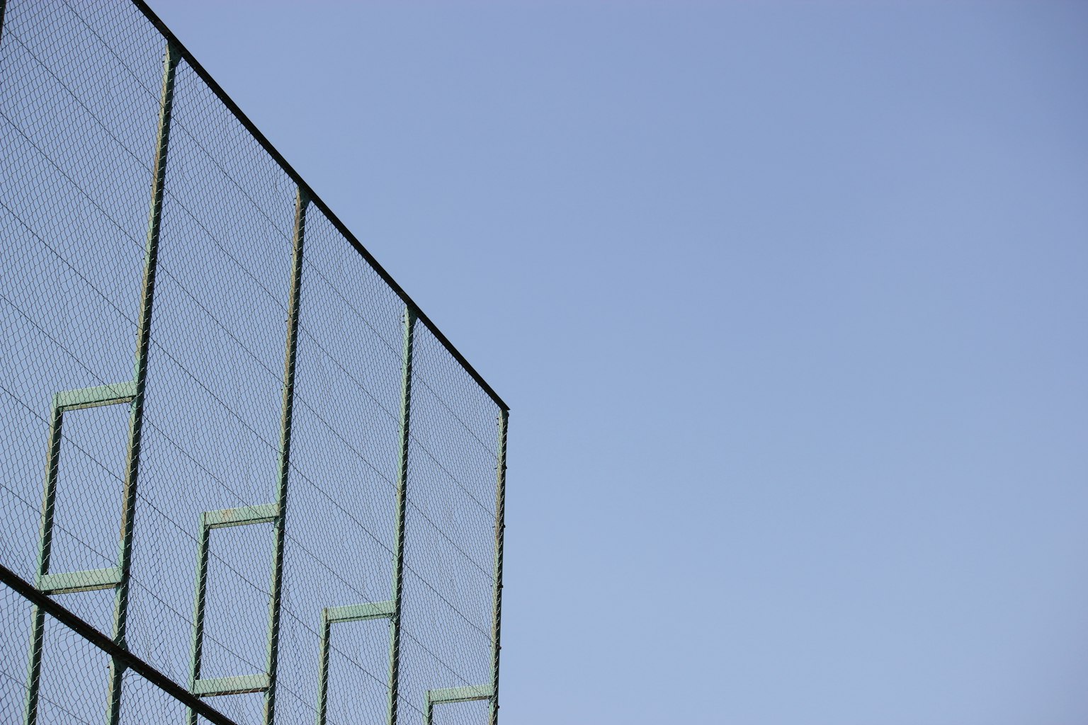 Part of a metal structure extending towards the blue sky