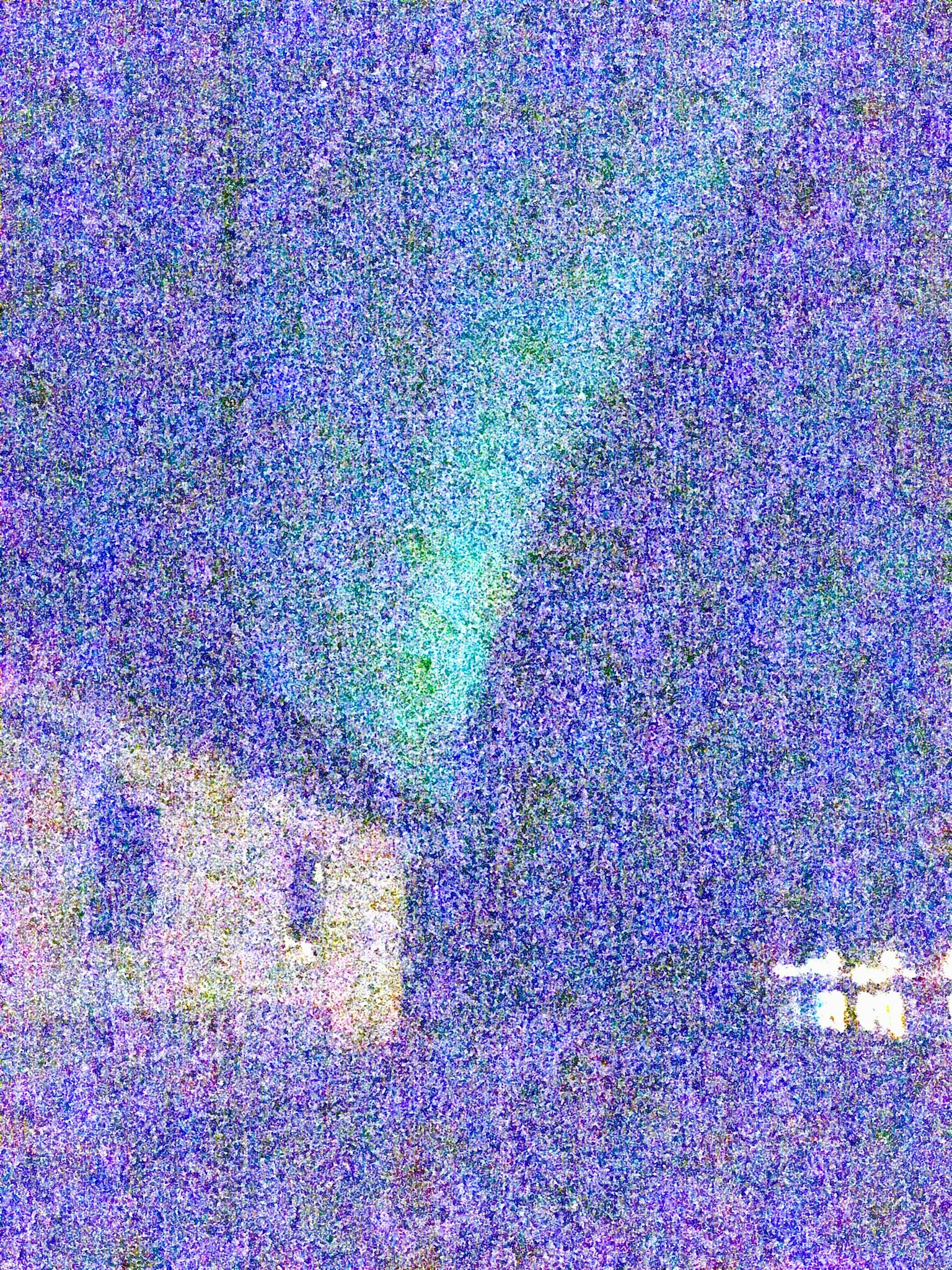 Aurora lights glowing in the night sky above a dark house