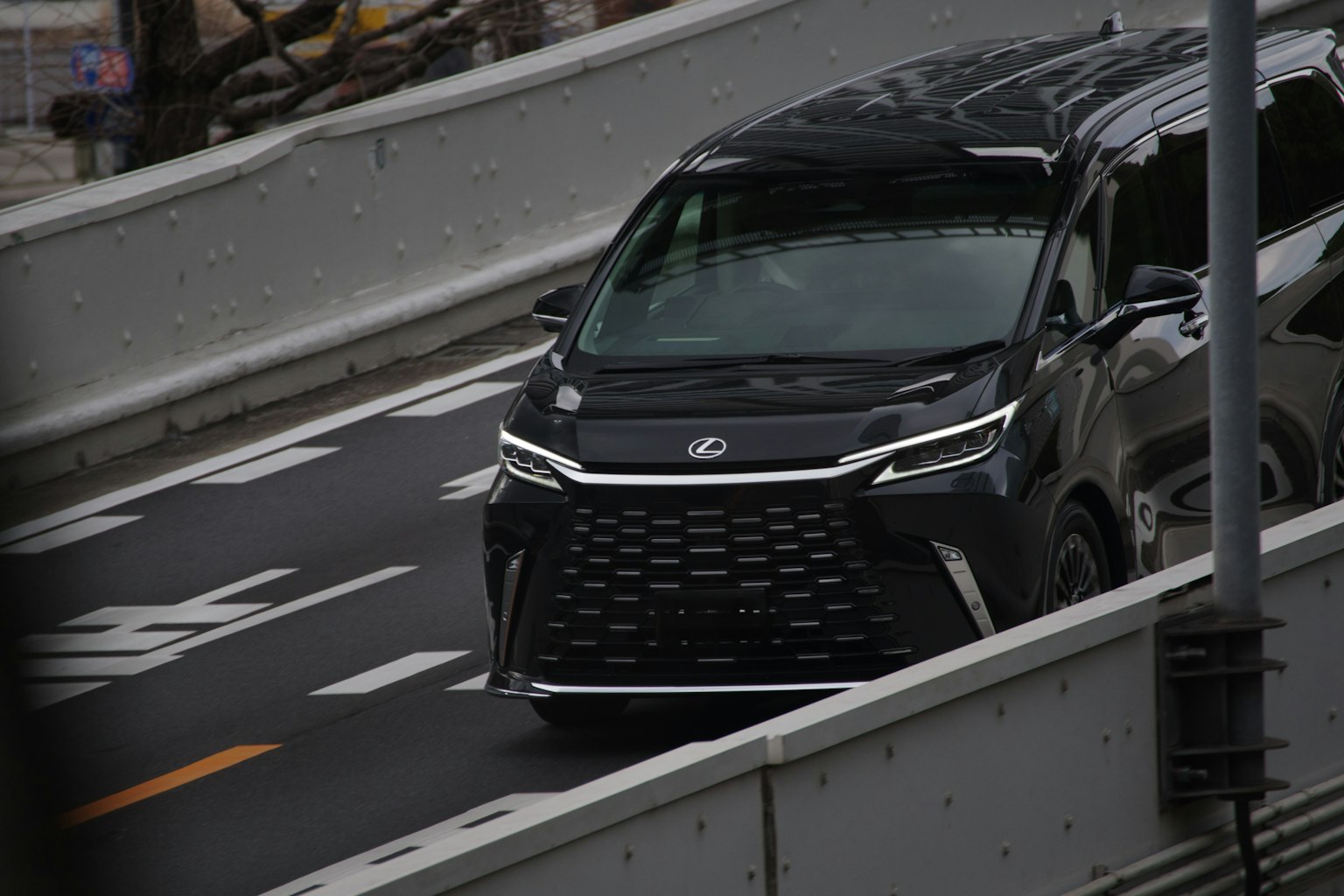 Black Toyota vehicle driving on the road