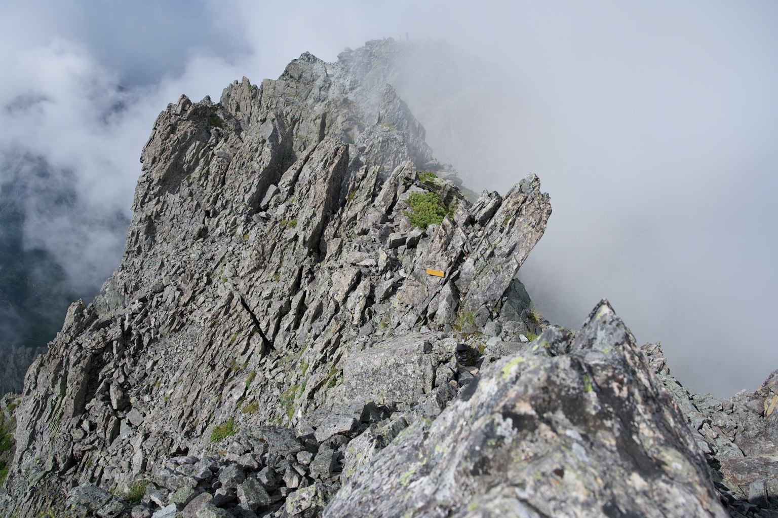 A rocky mountain peak surrounded by clouds