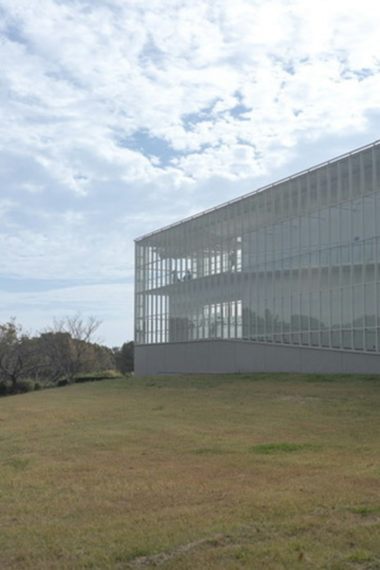 Edificio moderno con facciata in vetro trasparente e cielo blu