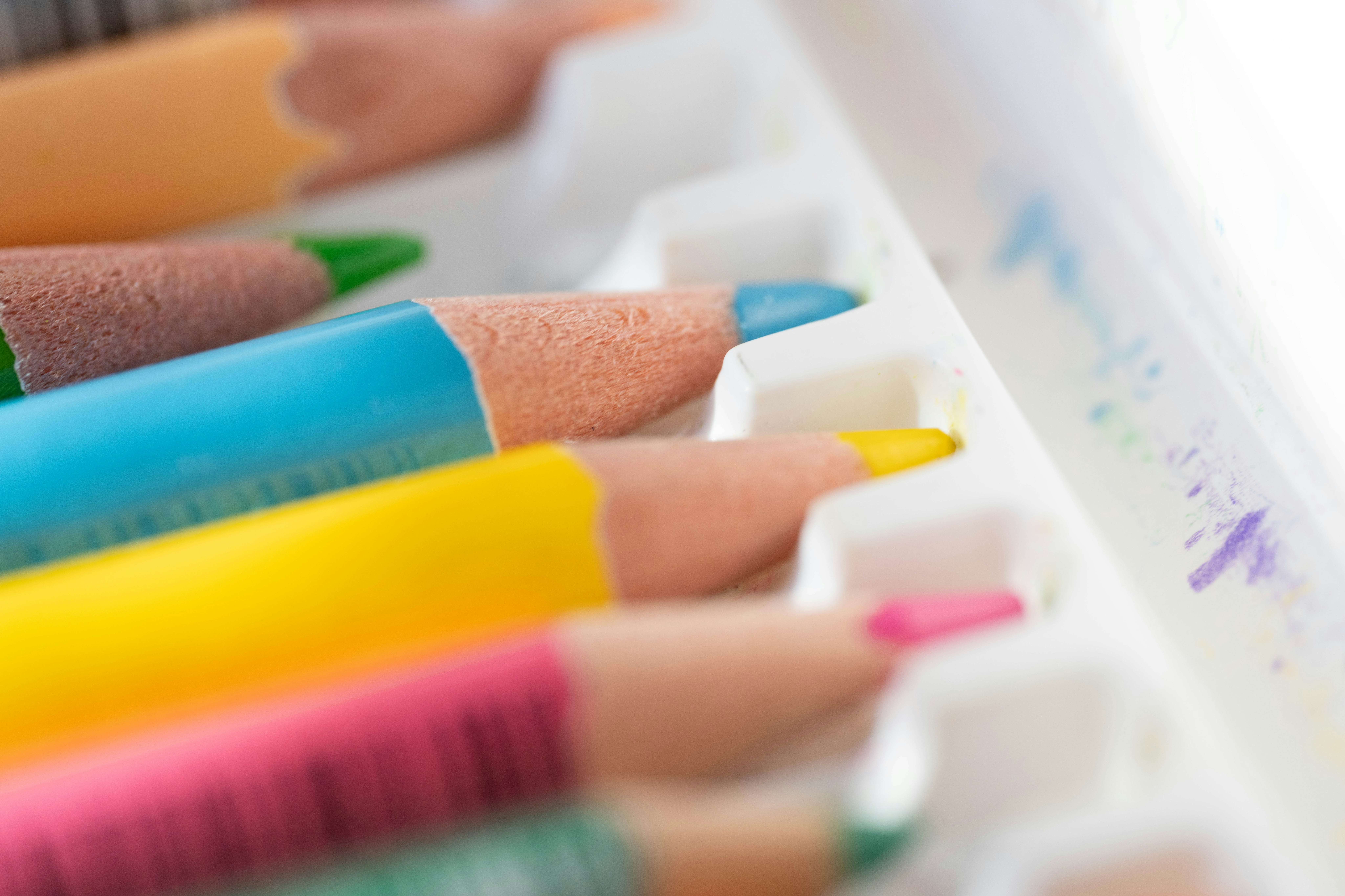 Colorful crayons lined up on a kids drawing table