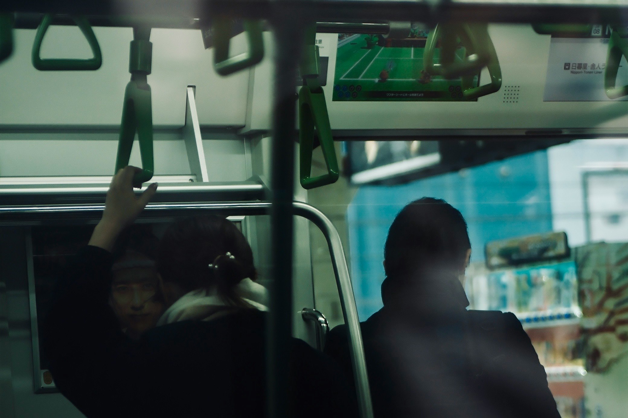 train window view with handrails and passenger silhouettes