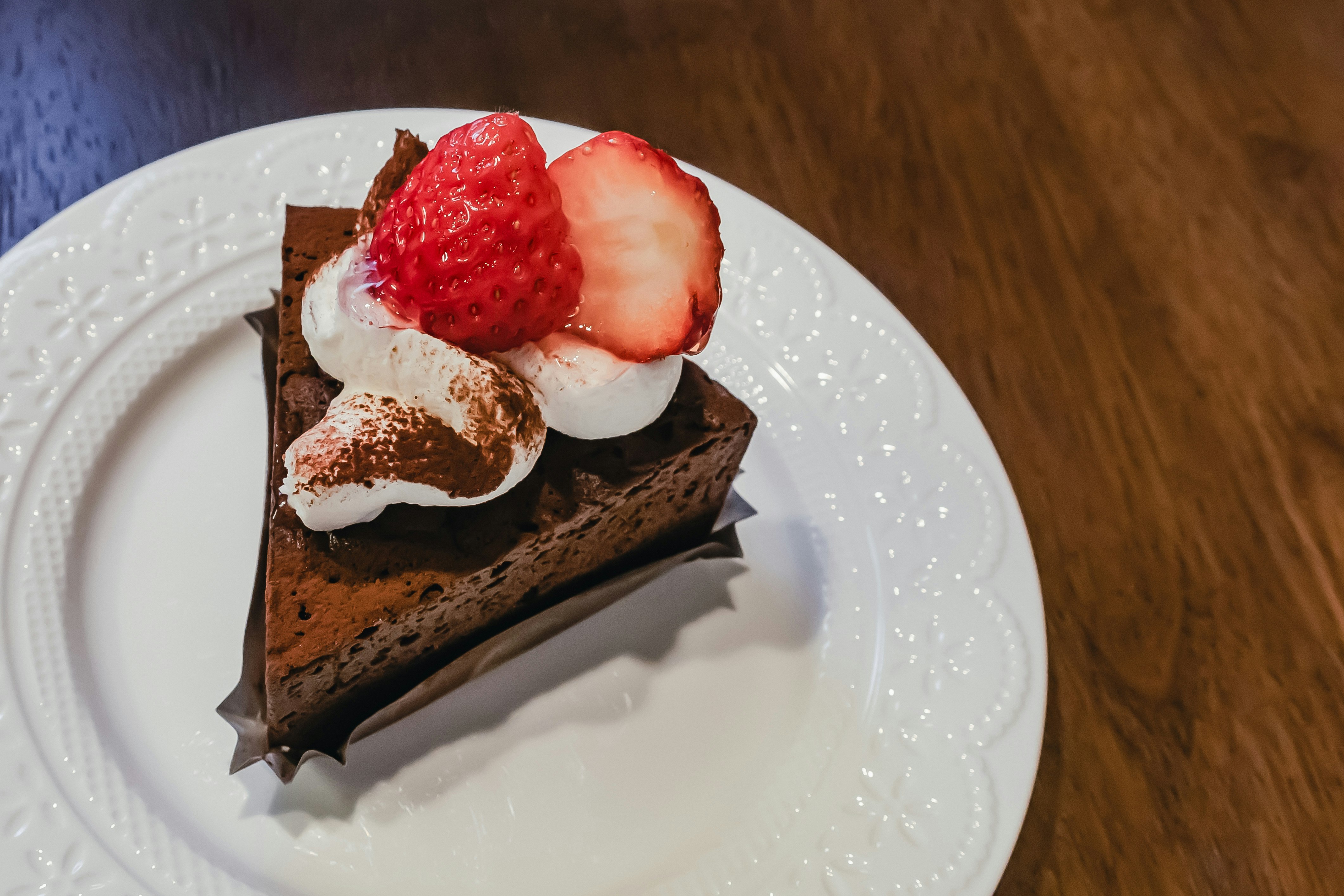 皿にのった苺のショートケーキとチョコレートケーキ