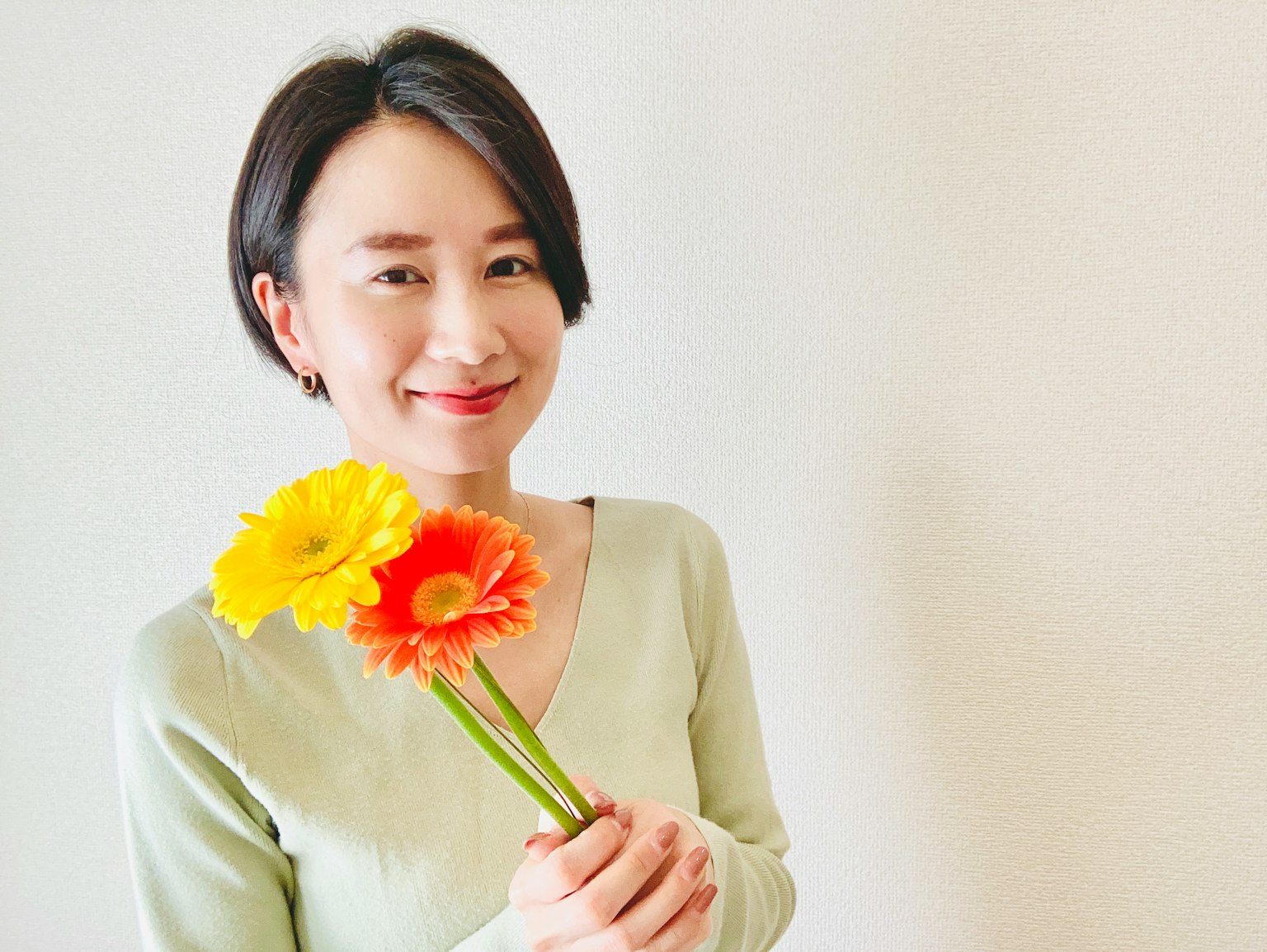 꽃을 들고 있는 여성의 초상화 밝은 색 꽃과 부드러운 배경