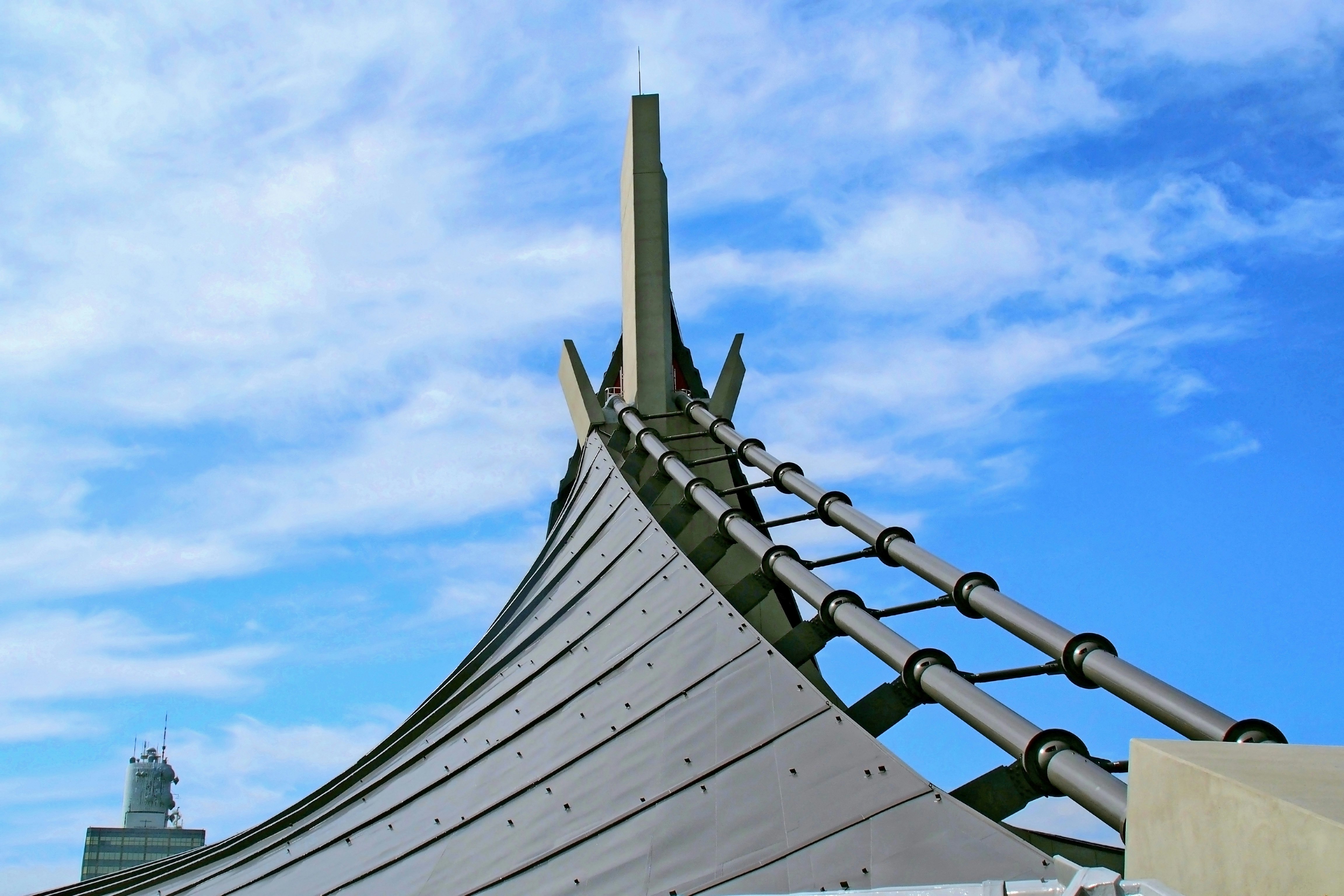 metal roof and spire under a blue sky
