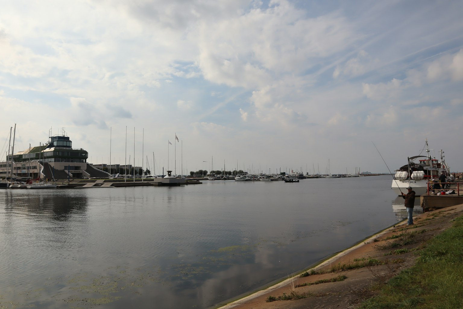 Calm harbor with moored boats and serene water surface