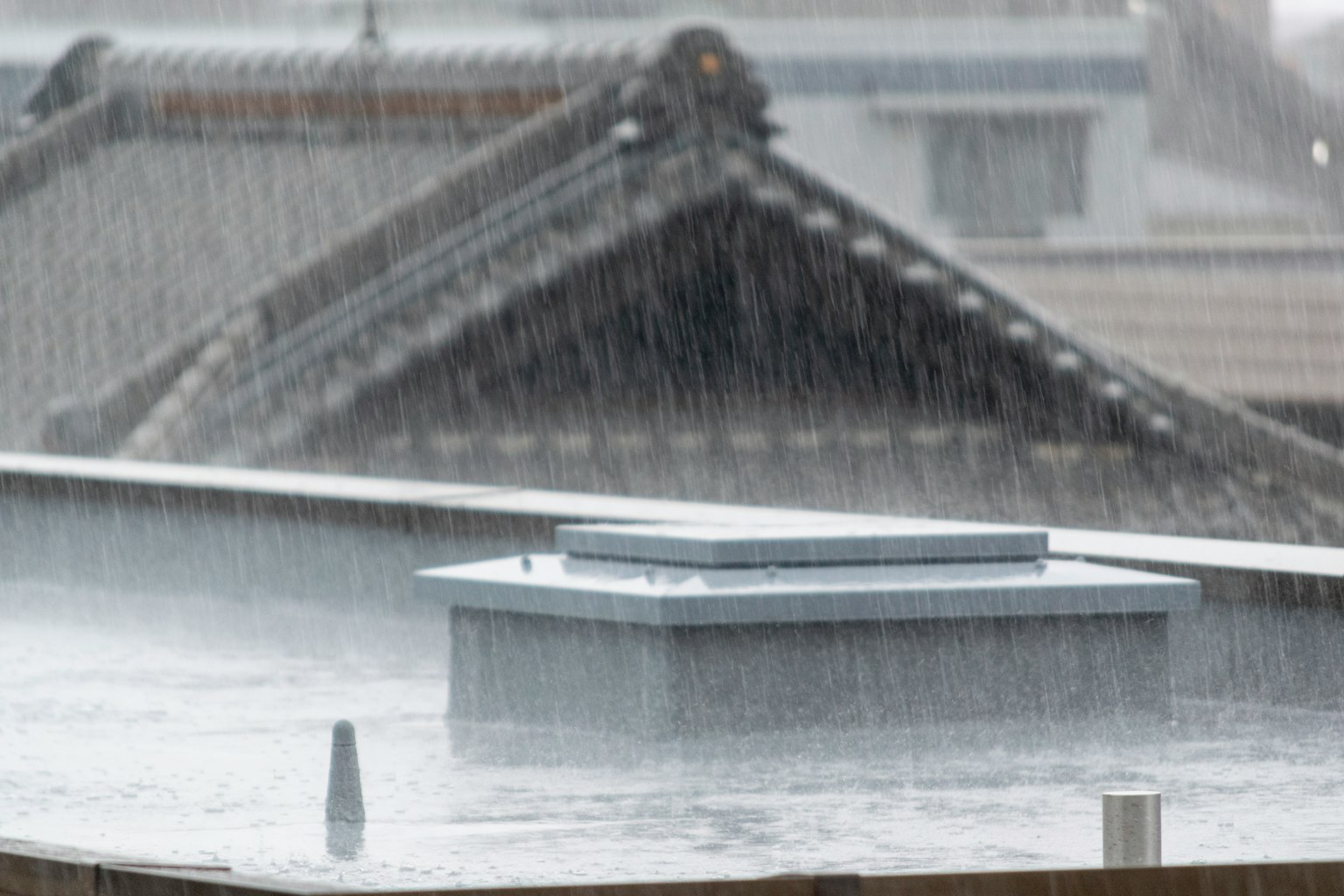 Ventilation duct on a rooftop during heavy rain