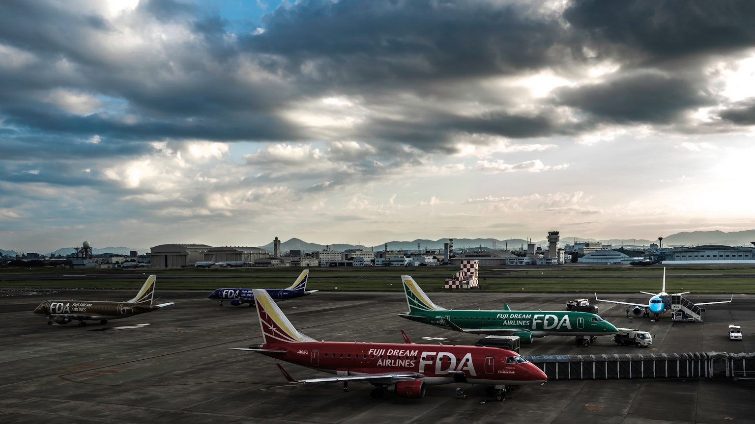 Mehrere Flugzeuge auf einem Flughafen unter einem bewölkten Himmel