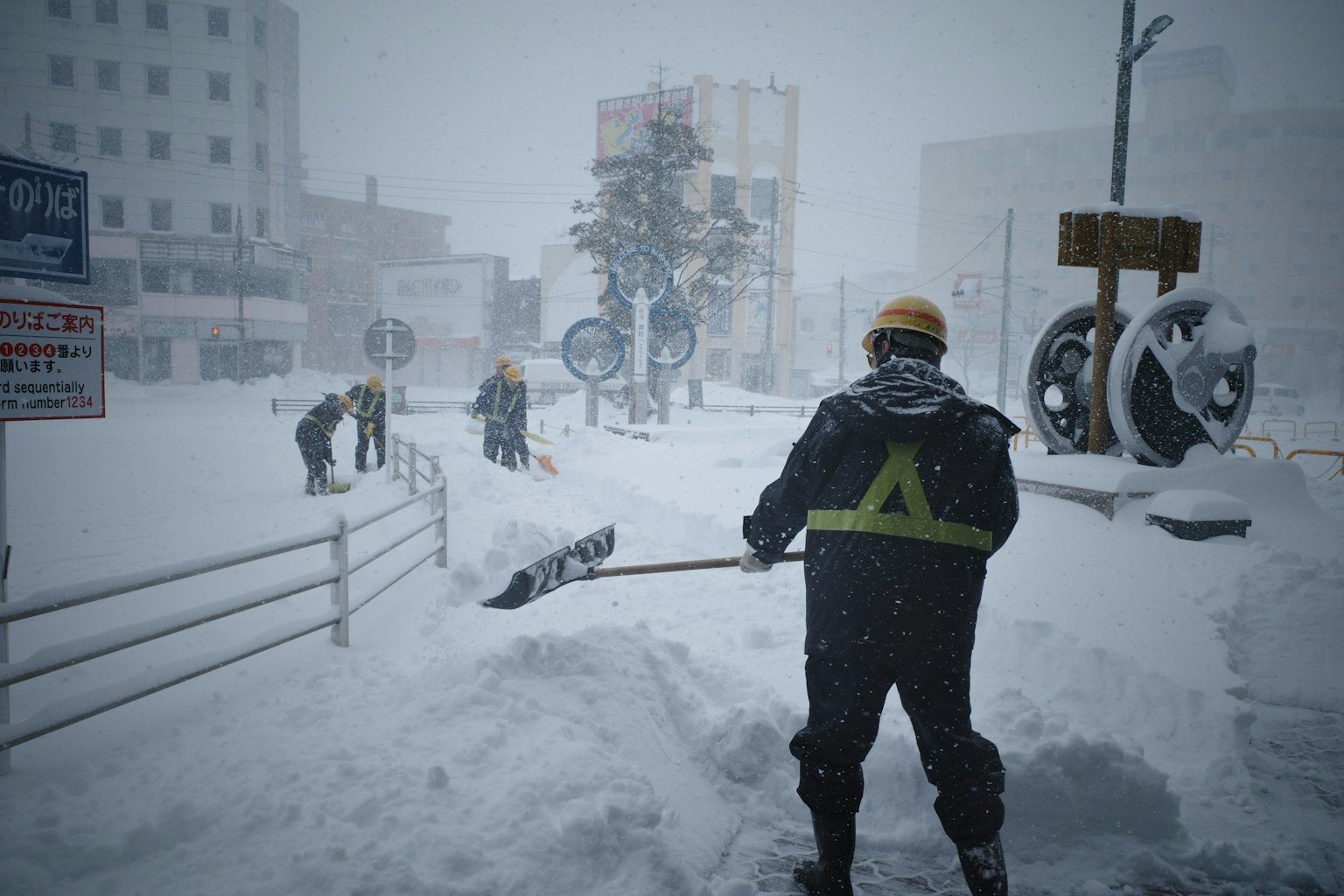 Des travailleurs déneigent pendant une forte chute de neige