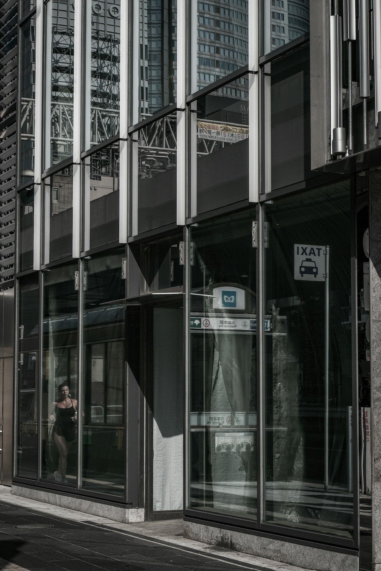 Glass facade of a modern building with surrounding skyscrapers