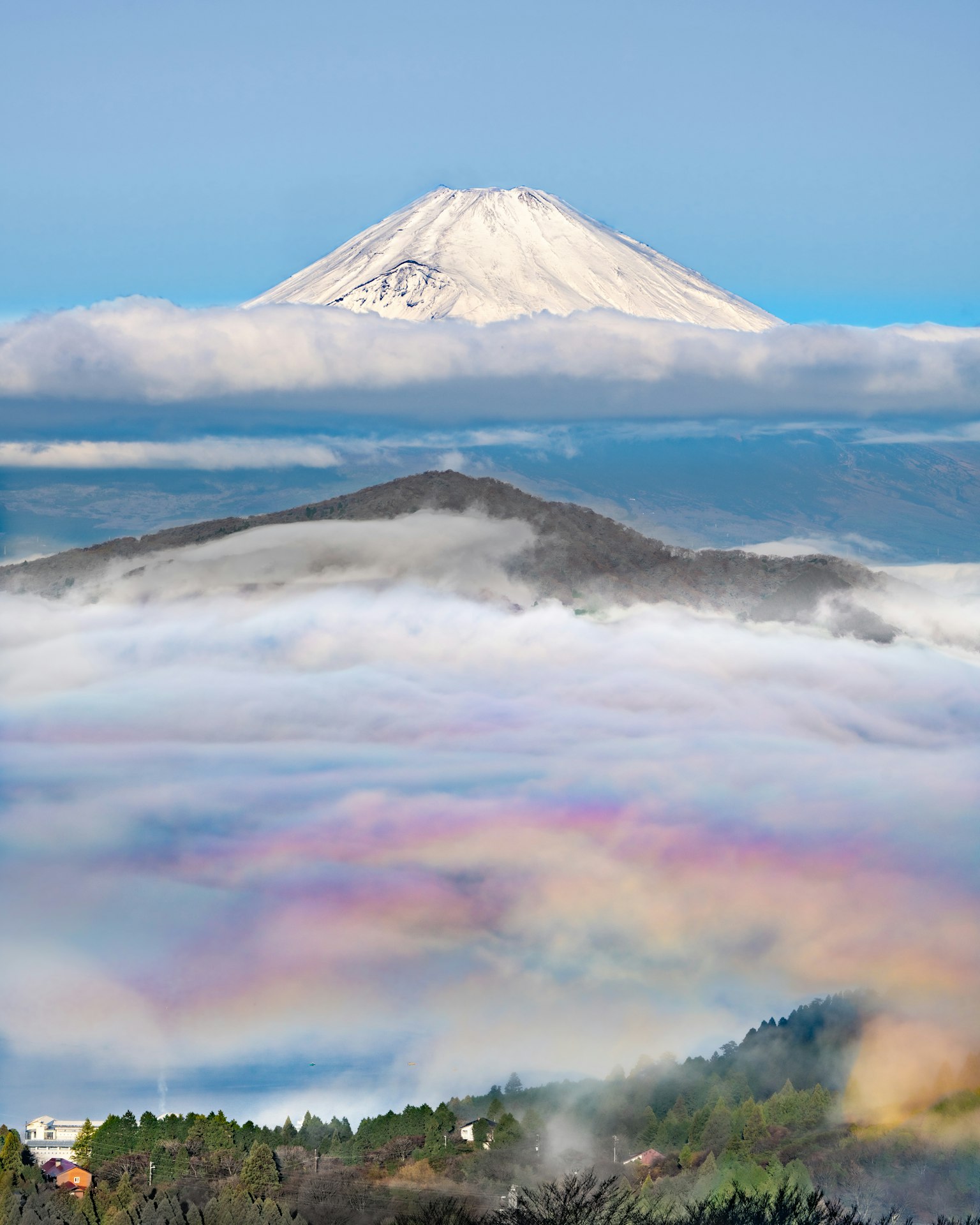 Mont Fuji majestueux se dressant au-dessus des nuages avec un brouillard coloré en dessous