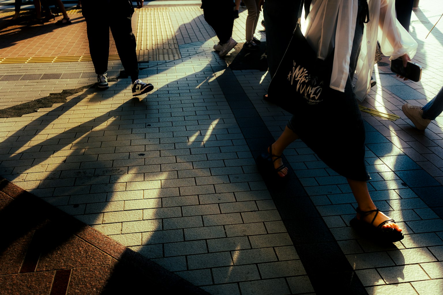 ฉากเมืองที่มีเงาของคนเดินและลวดลายกระเบื้องที่ซับซ้อน