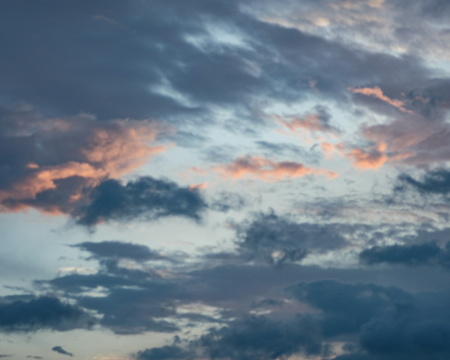 Beautiful sunset with pink and orange clouds against a blue sky