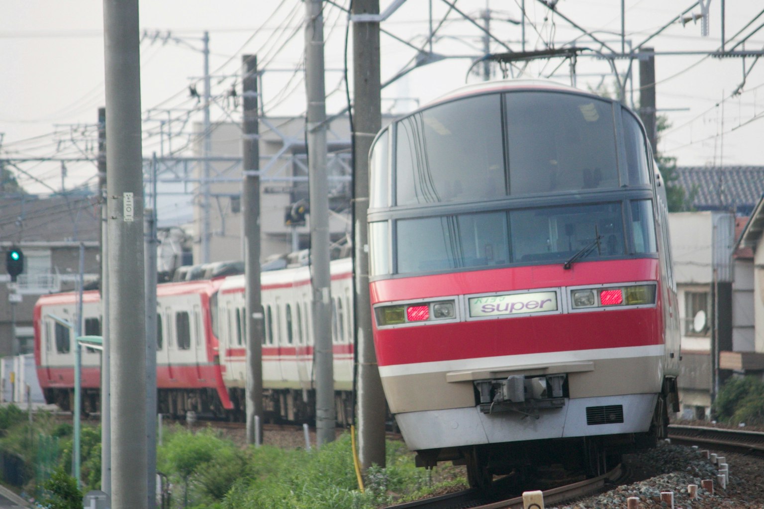 A red train navigating a curve on the tracks