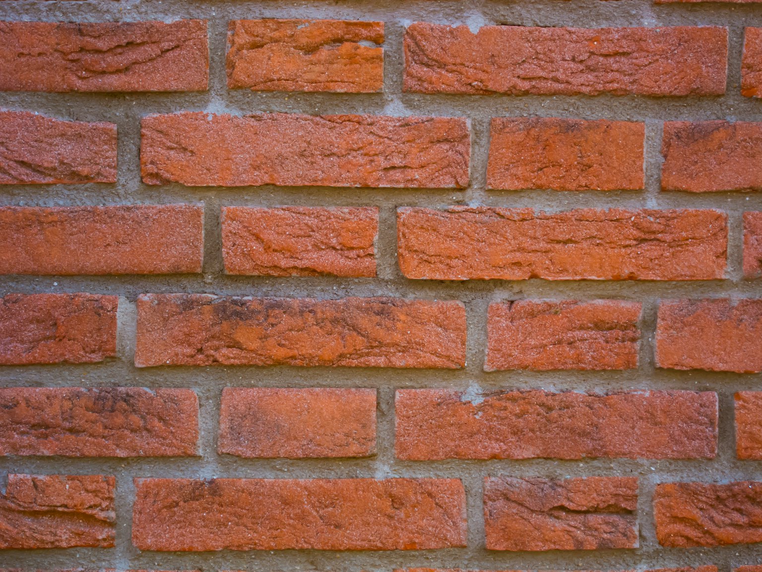 Mur en briques de couleur rougeâtre avec texture