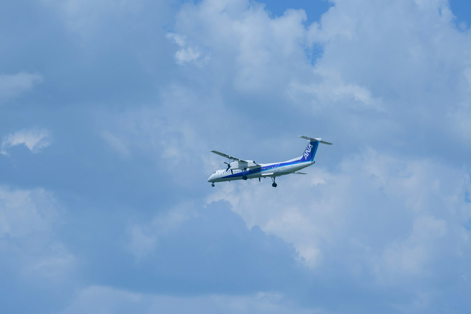 Small propeller plane flying in a blue sky