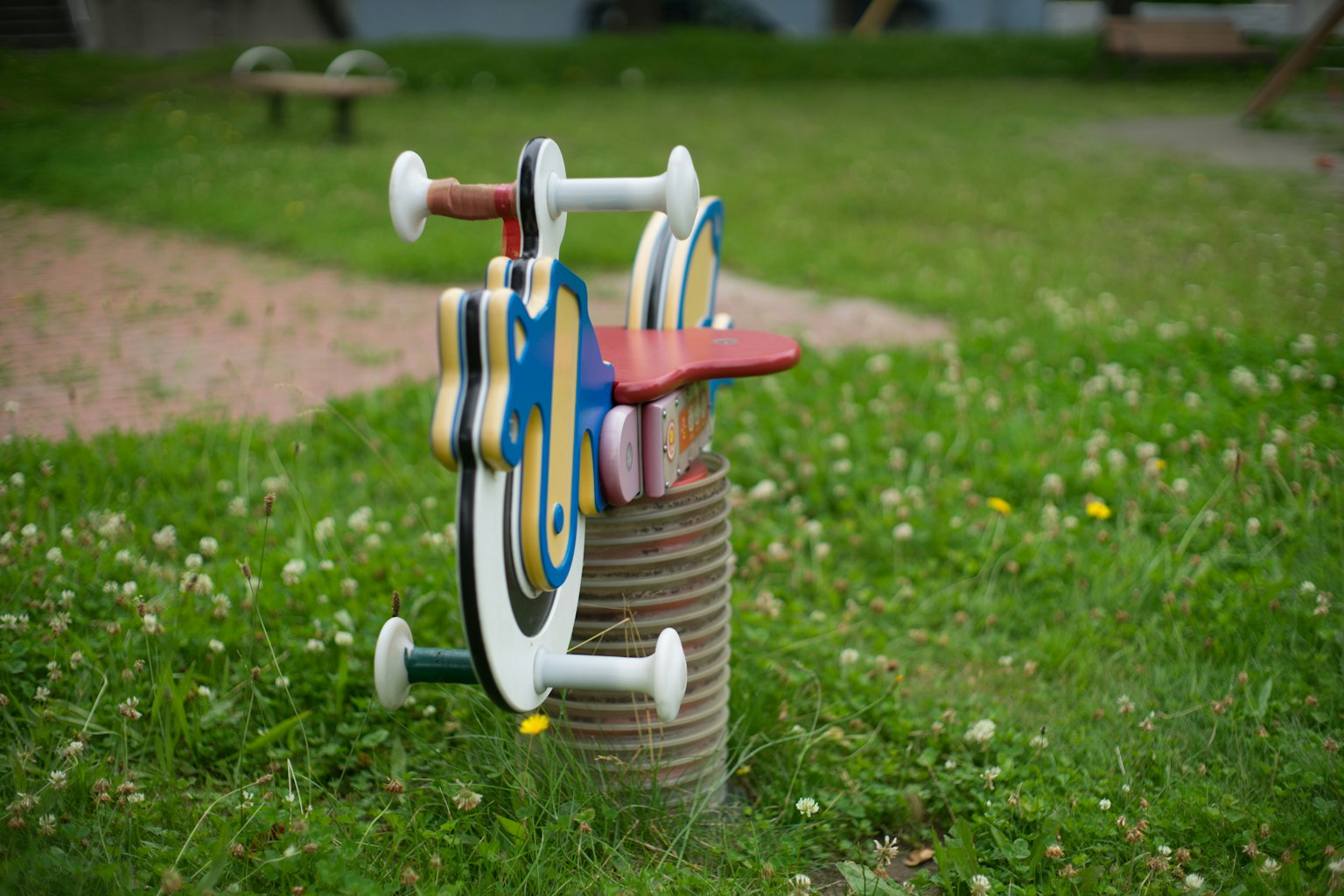 Colorful children's playground equipment on green grass