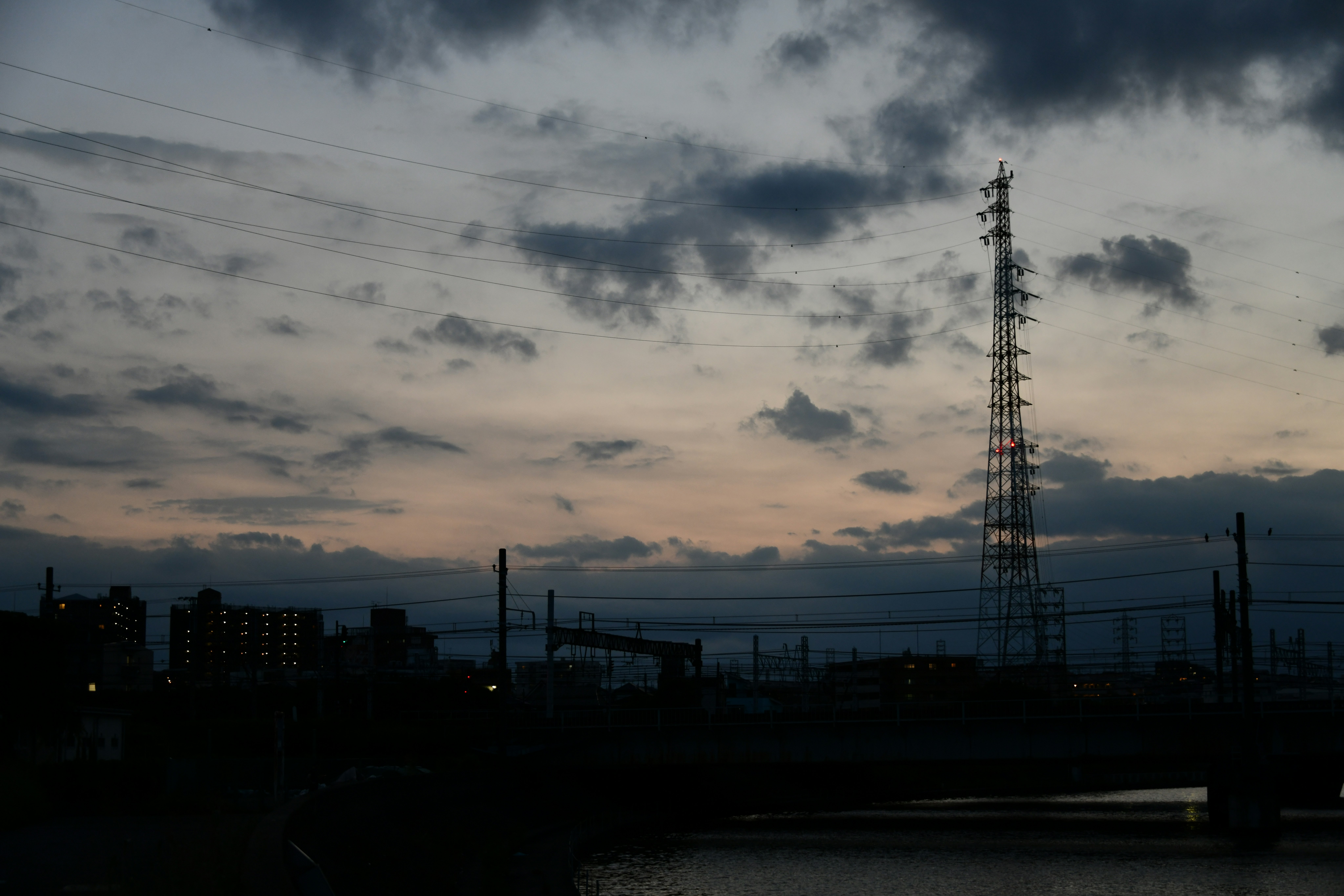 industrial skyline at dusk with power transmission towers