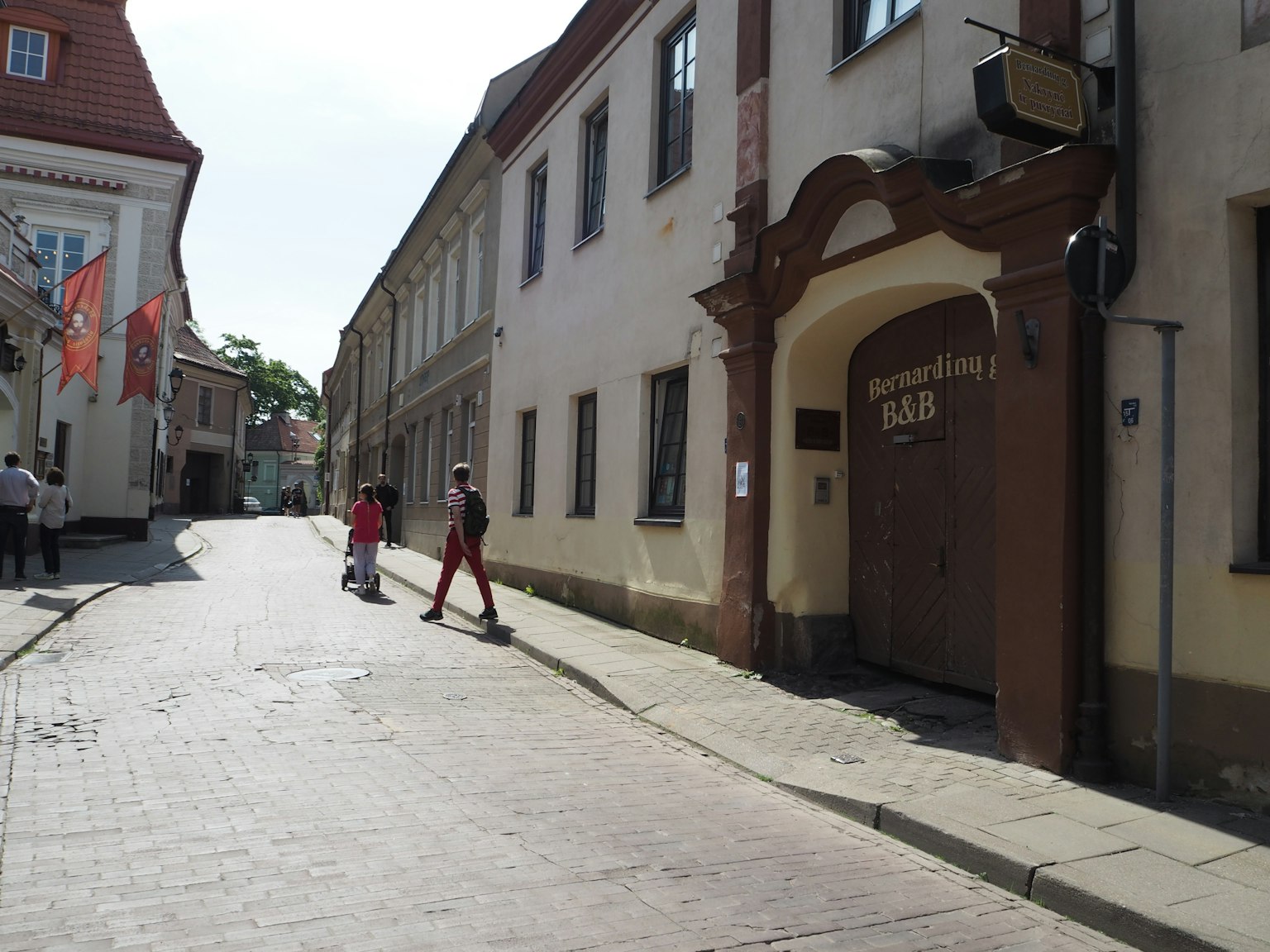 Quiet street with people walking and historic buildings