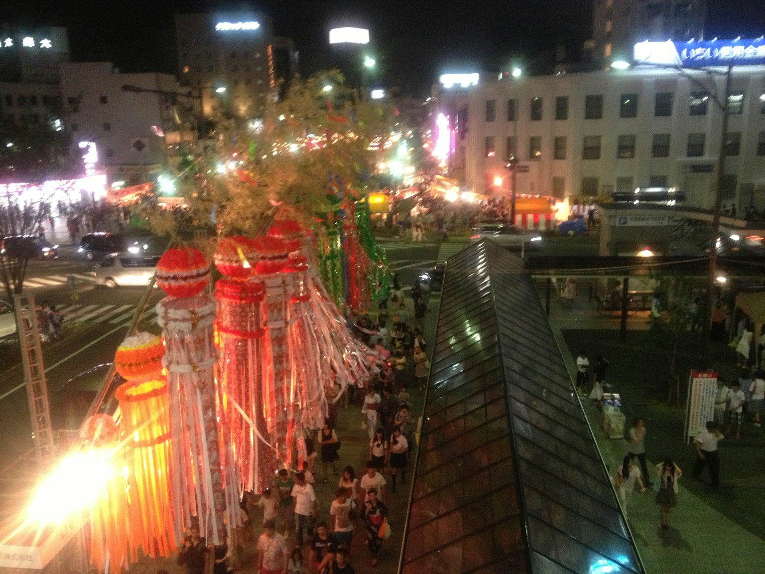 Busy street at night with colorful lanterns during a festival
