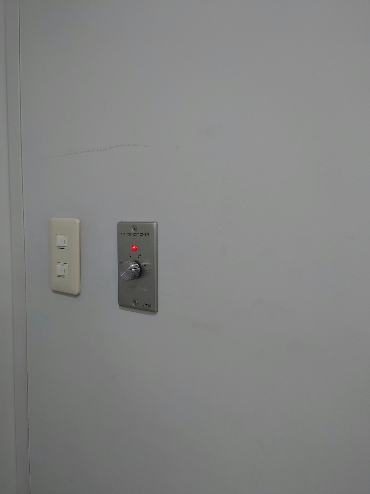 Switch and button panel mounted on a white wall