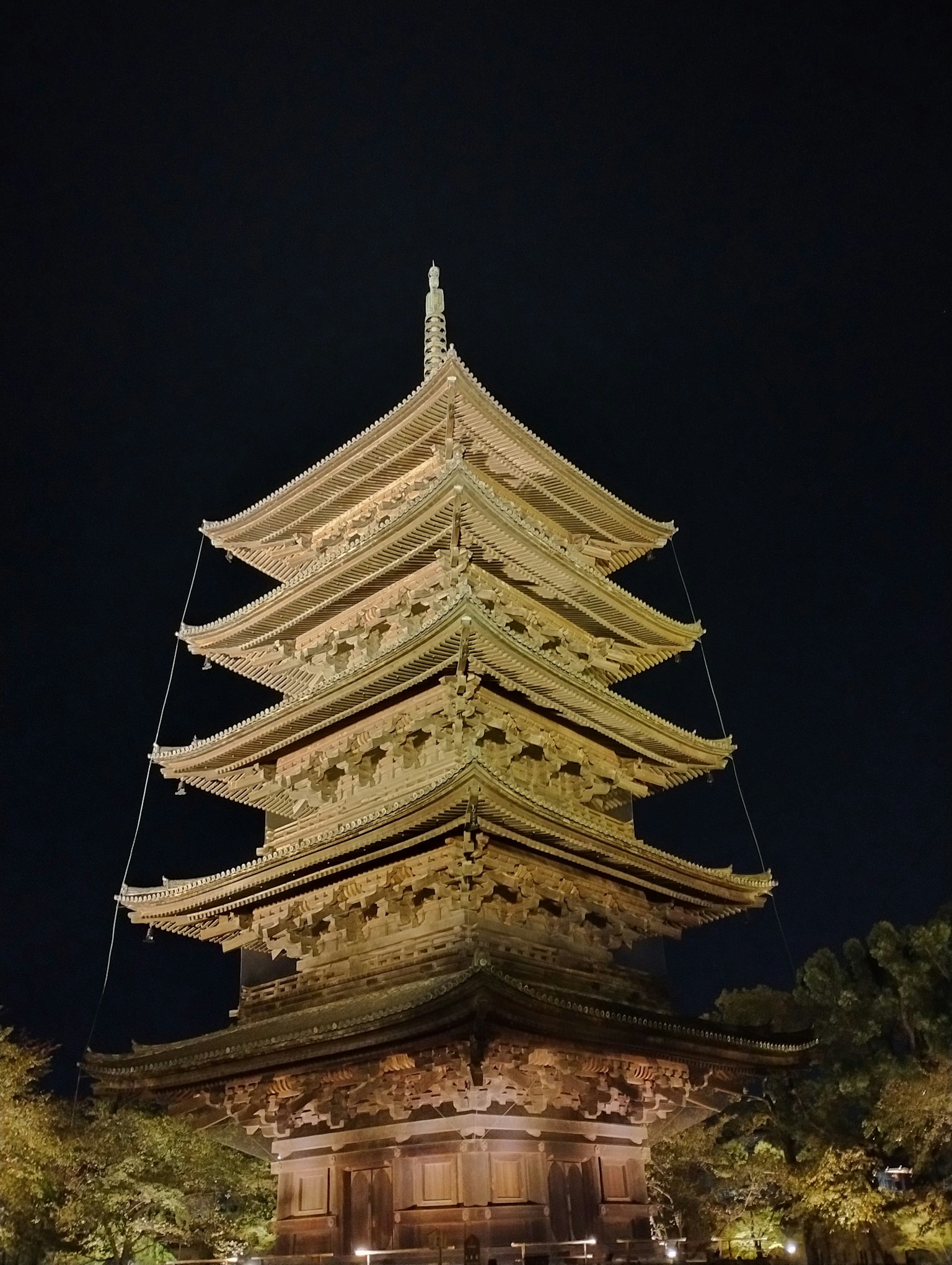 Illuminated pagoda at night showcasing intricate details