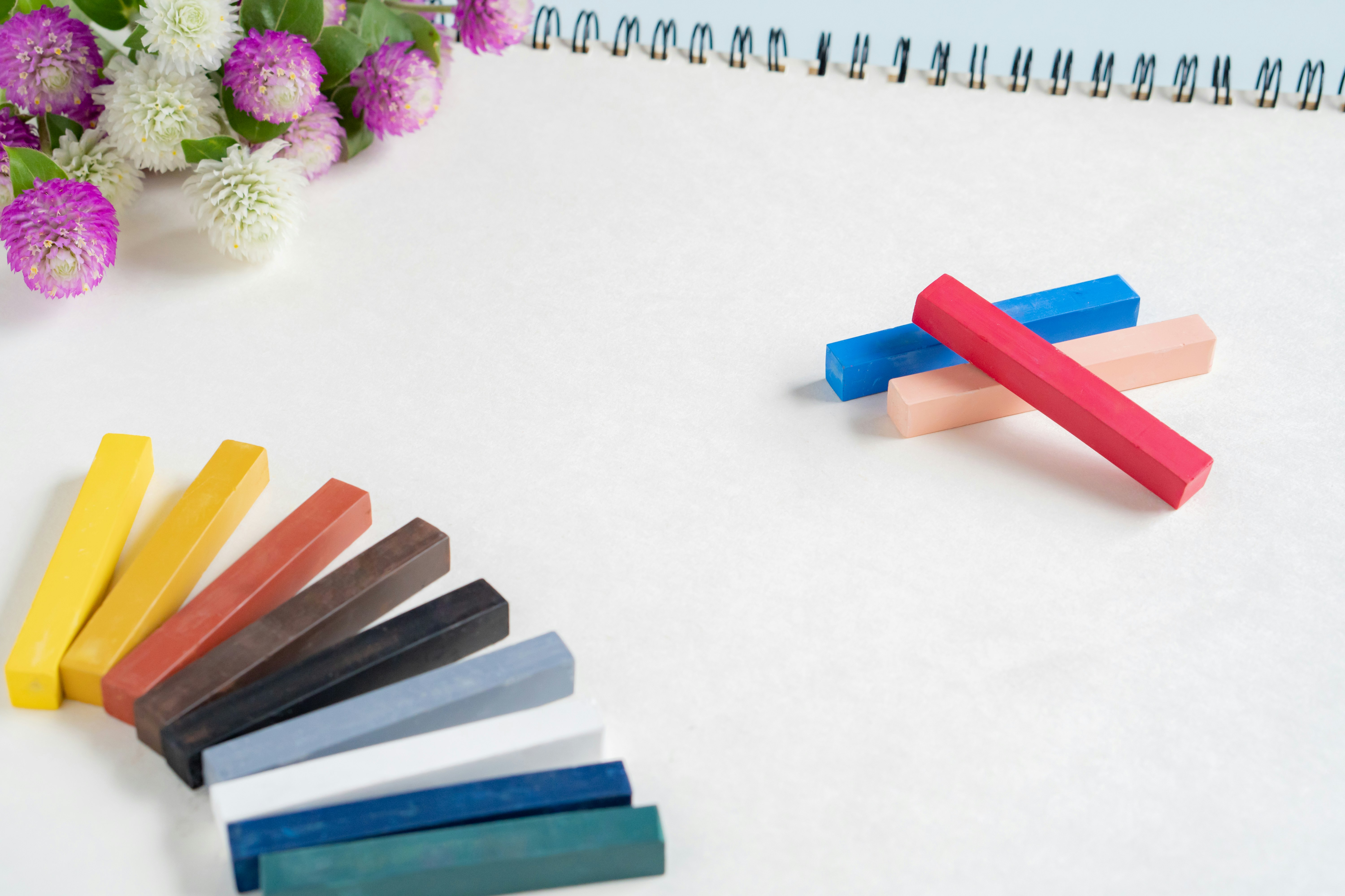 Colorful erasers, flowers, and a notebook on a study desk