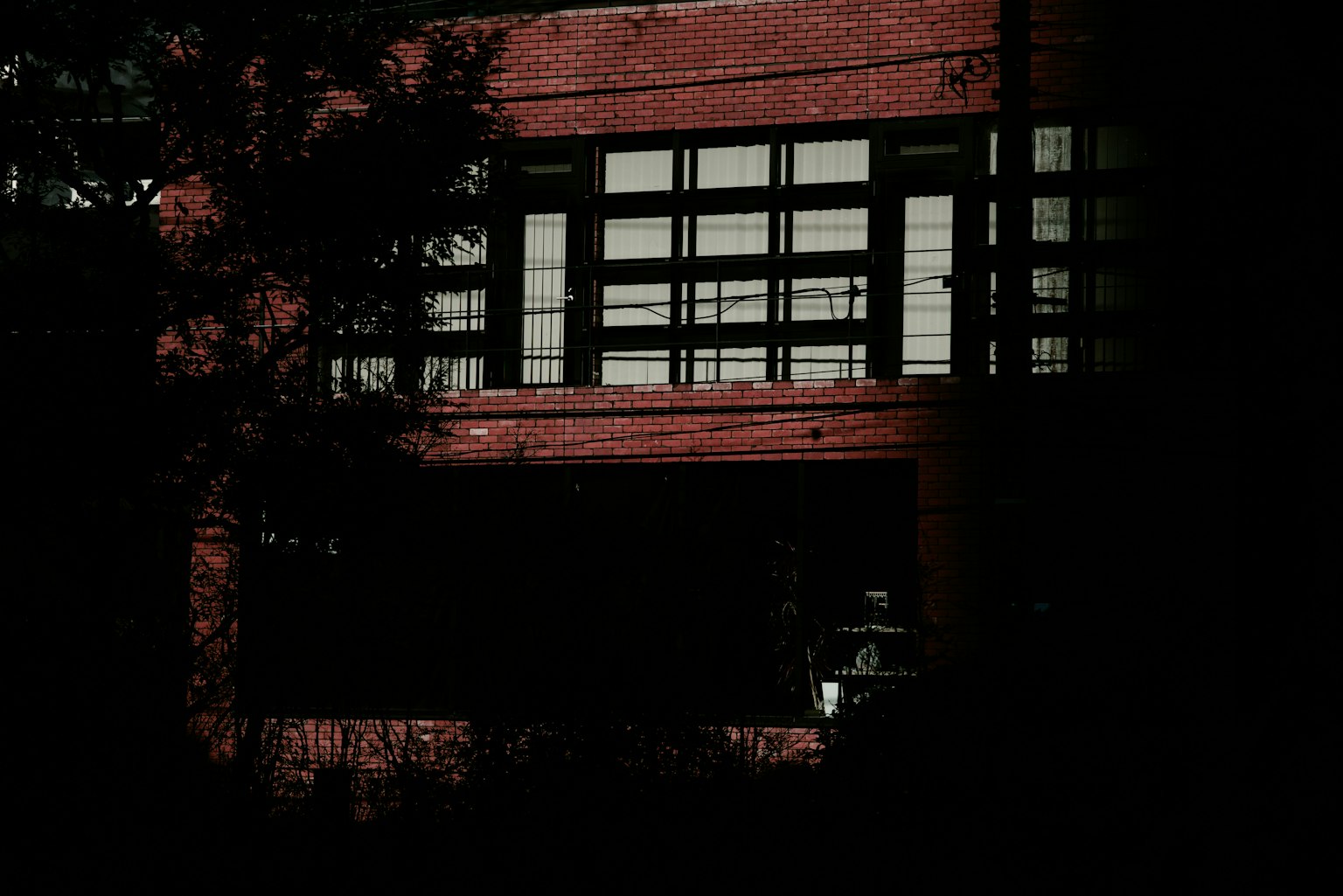 Image of a red brick building with large windows