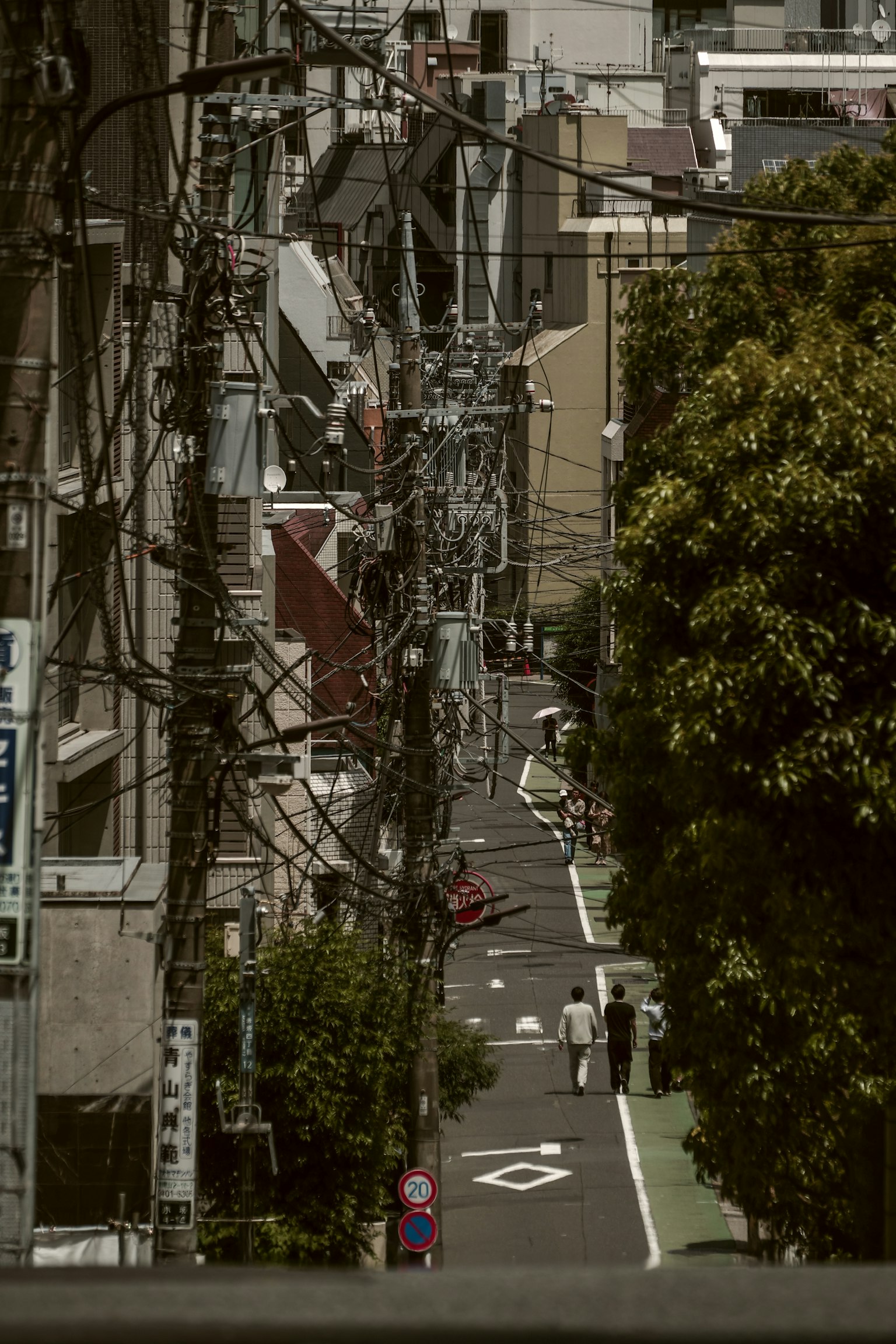Narrow alley with buildings and power lines in a Tokyo neighborhood