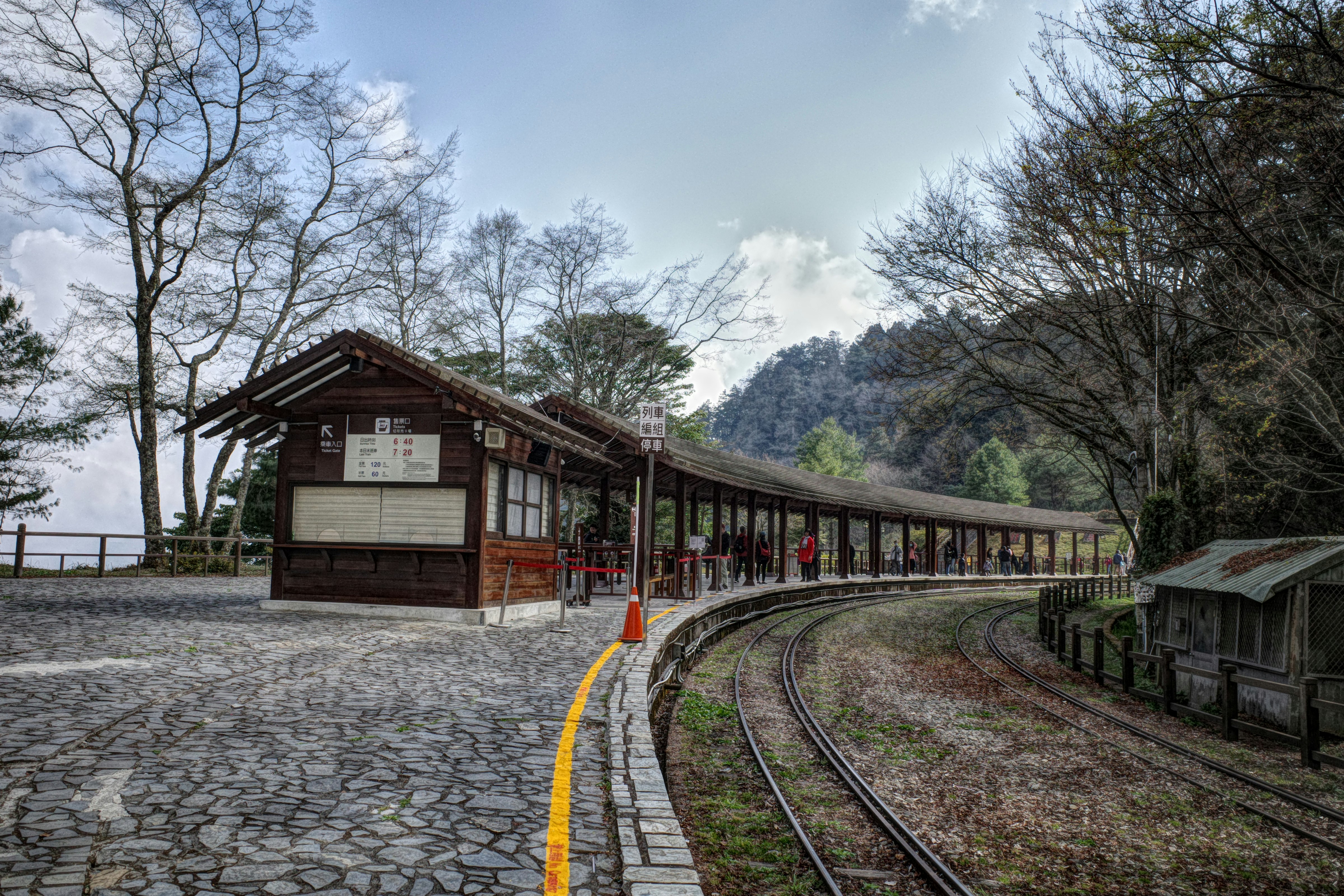 台湾の山あいの駅舎と線路が続く風景