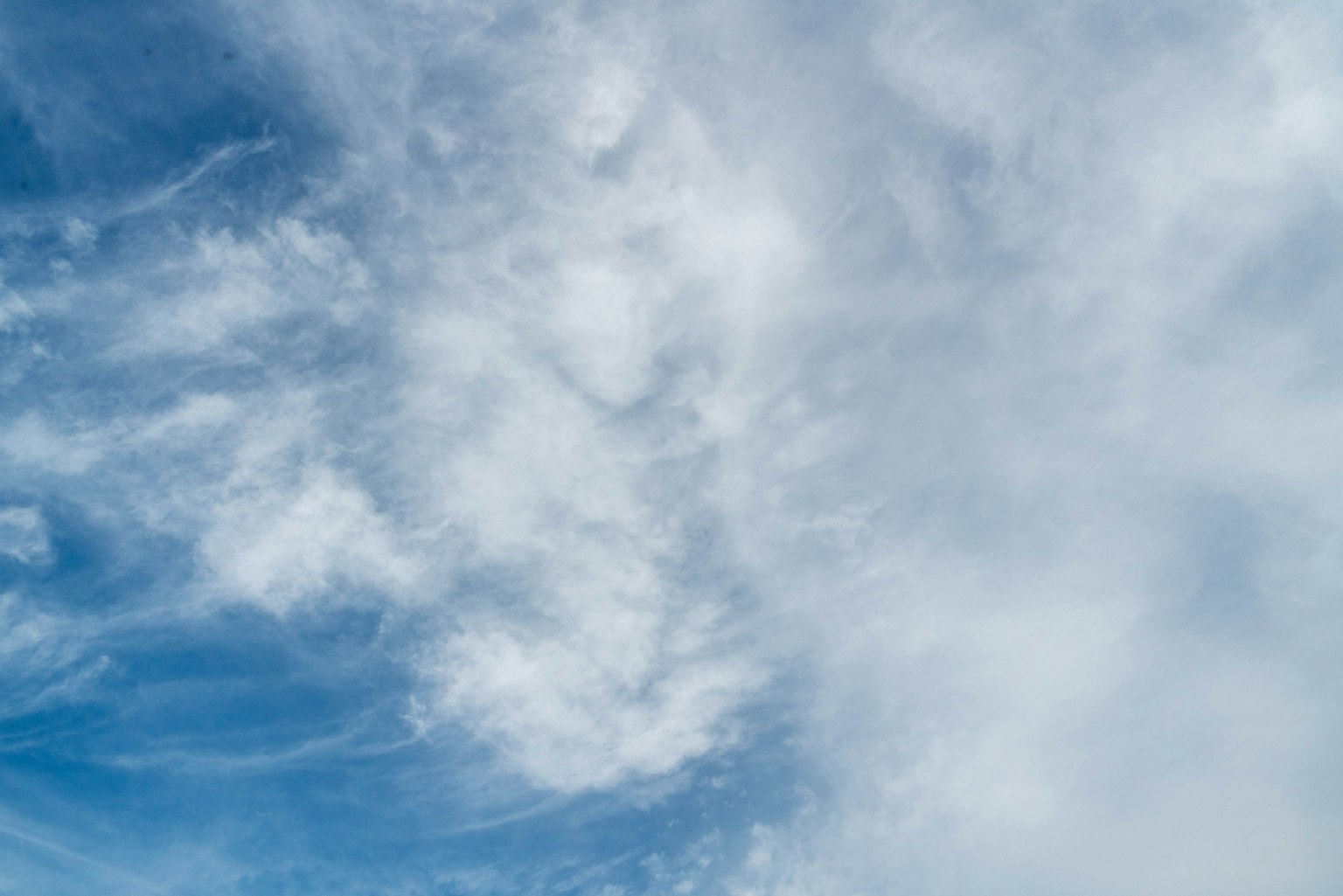 Sky with blue hues and white clouds