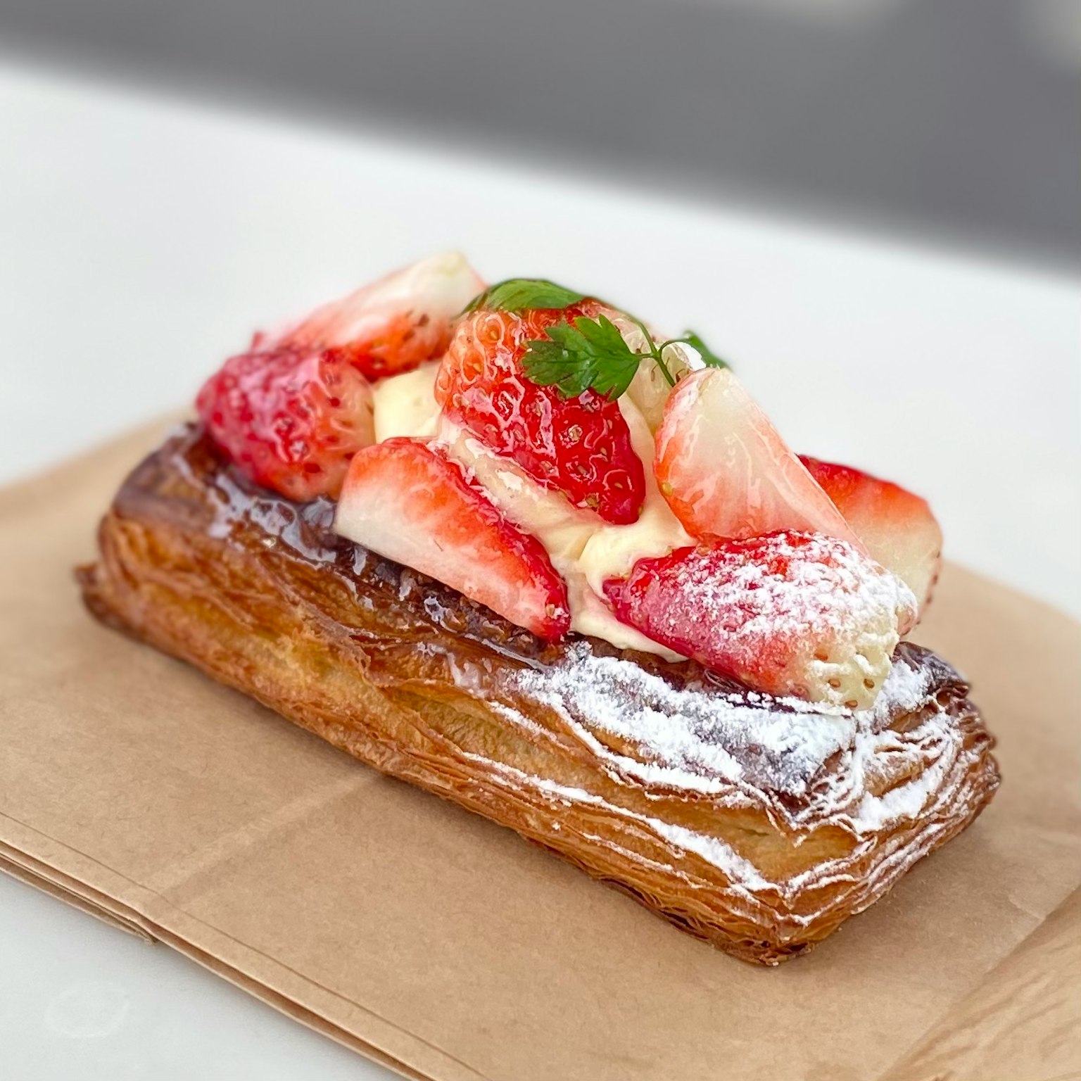 Pastry topped with strawberries and cream