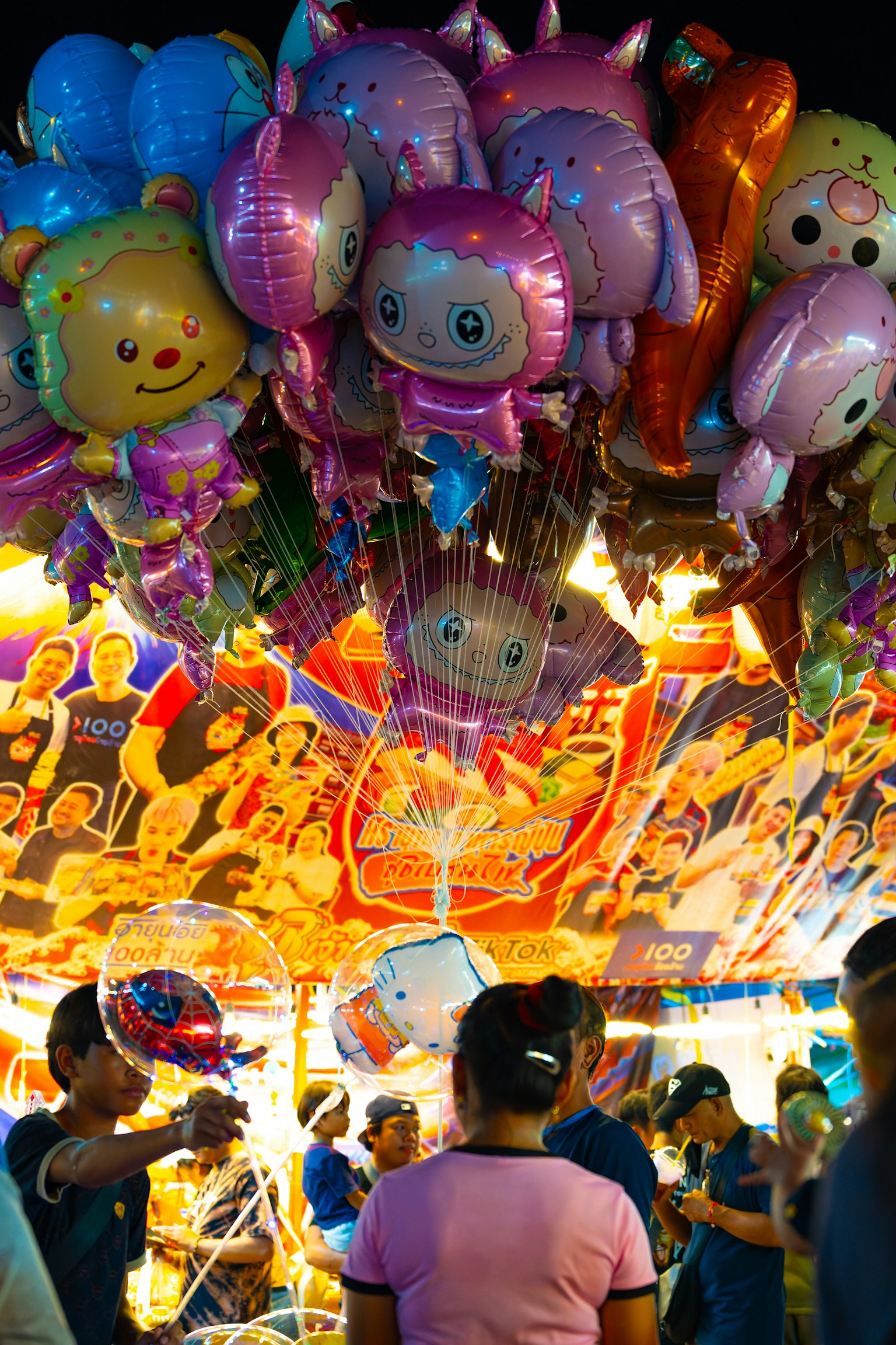 Eine festliche Szene mit bunten Figurenballons, die über einer lebhaften Atmosphäre hängen