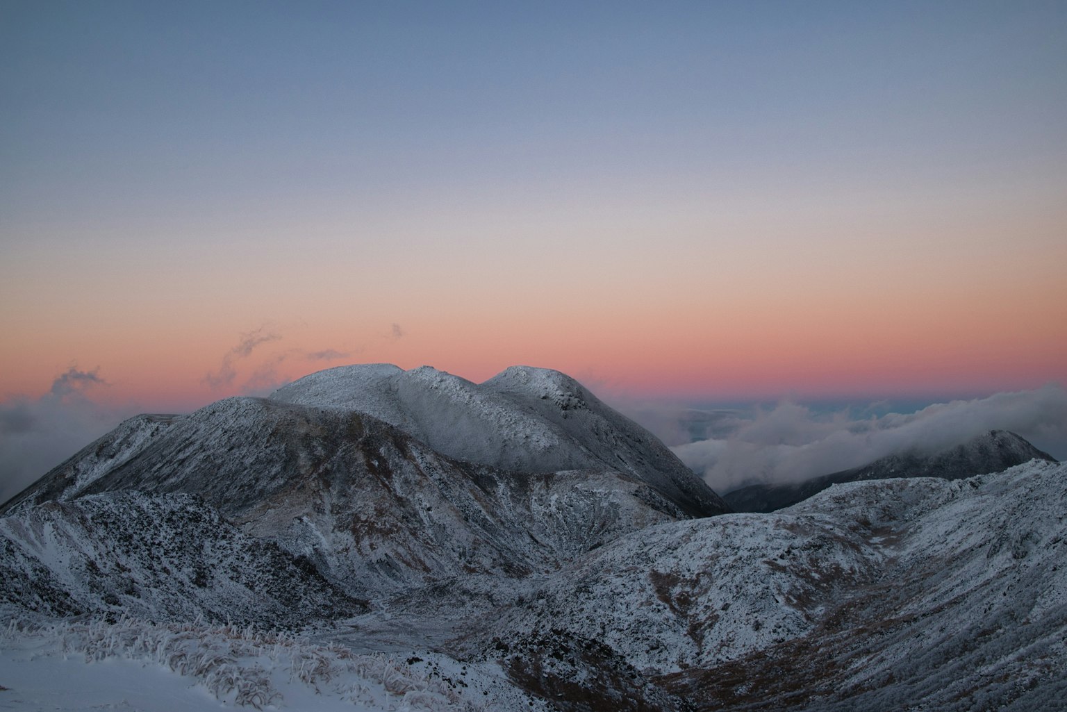 Gunung bersalju di bawah langit lembut fajar