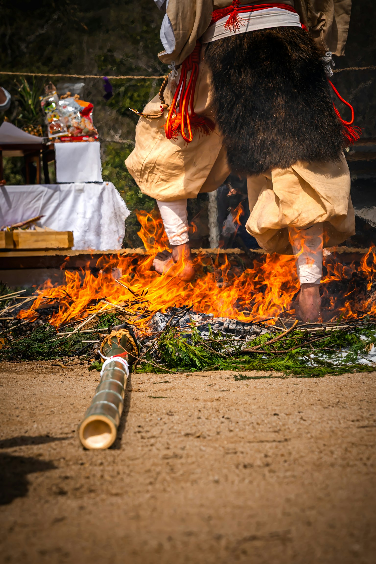Image of a participant walking over fire during a traditional ritual