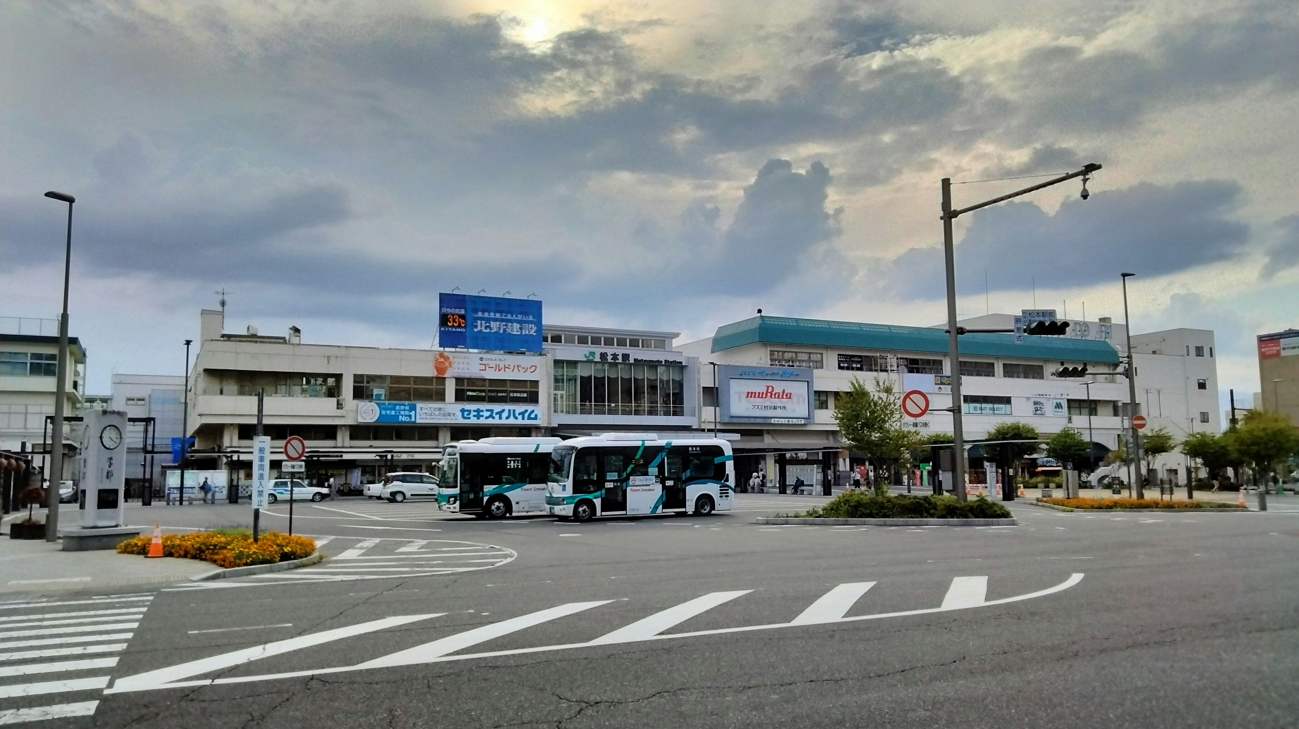 buses and storefronts along a city intersection