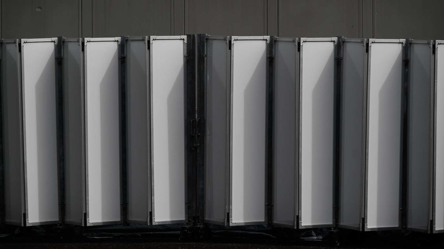 Row of white panels against a black background