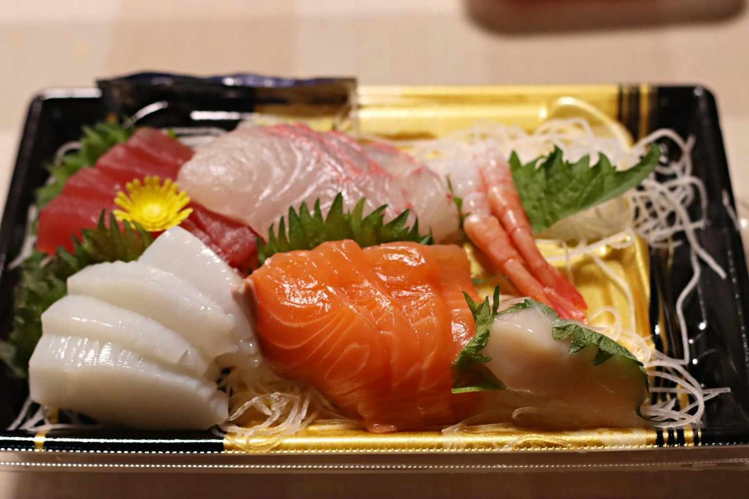 A beautifully arranged sashimi platter featuring various types of fresh fish