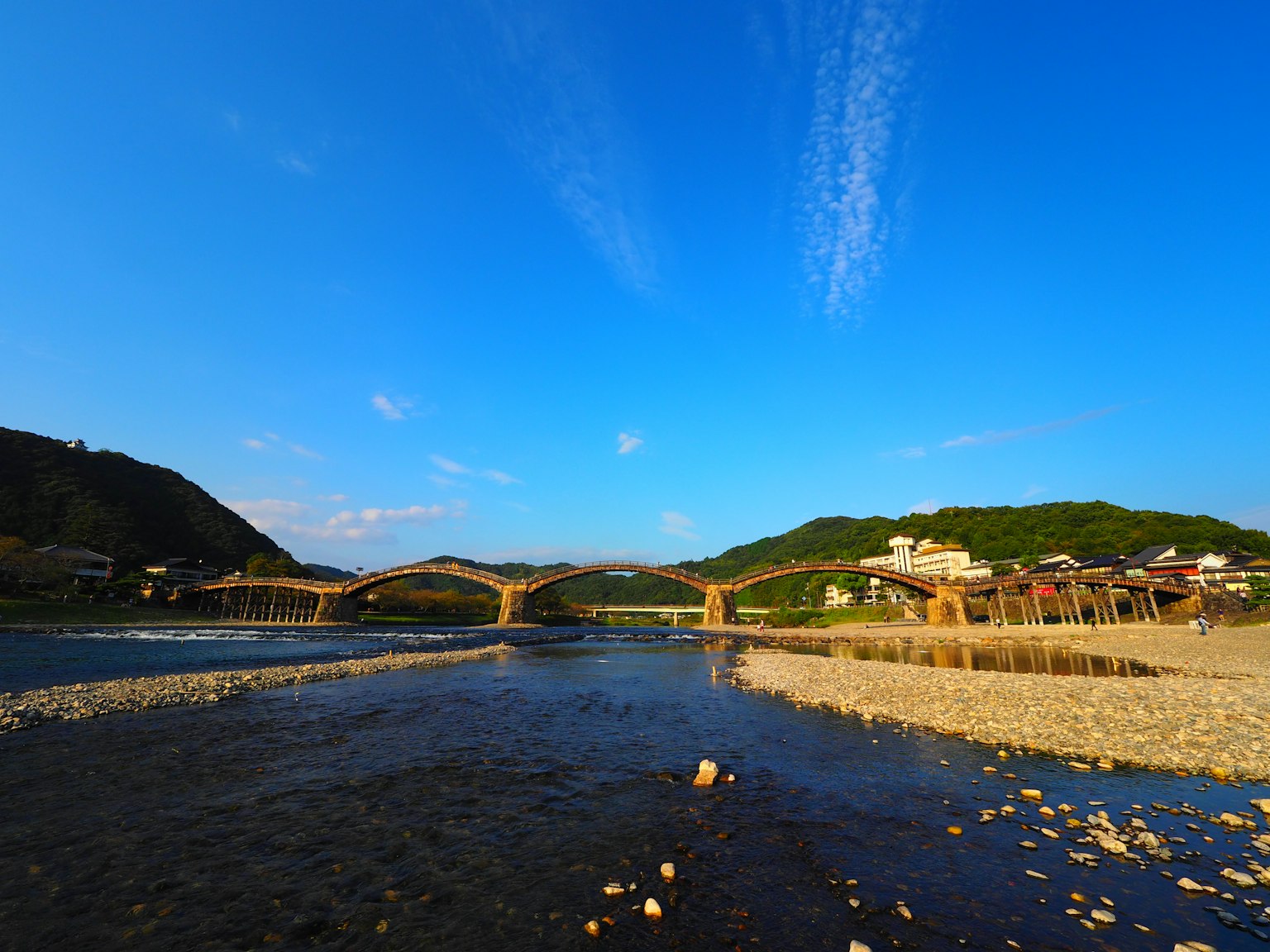 Vue pittoresque d'une rivière avec un pont sous un ciel bleu