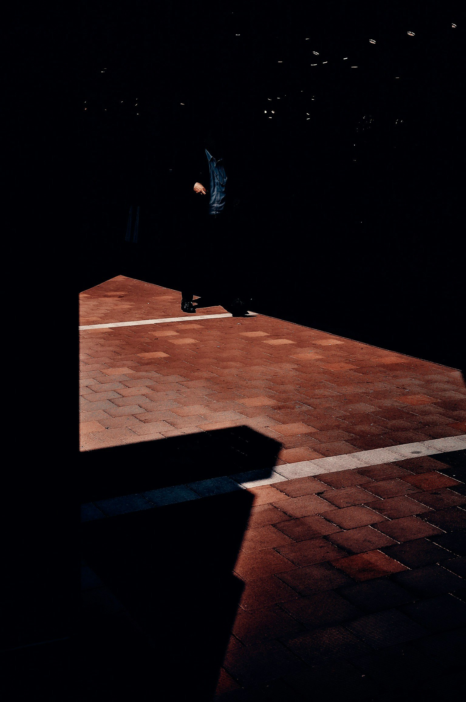 shadows and light projection across a dark floor image