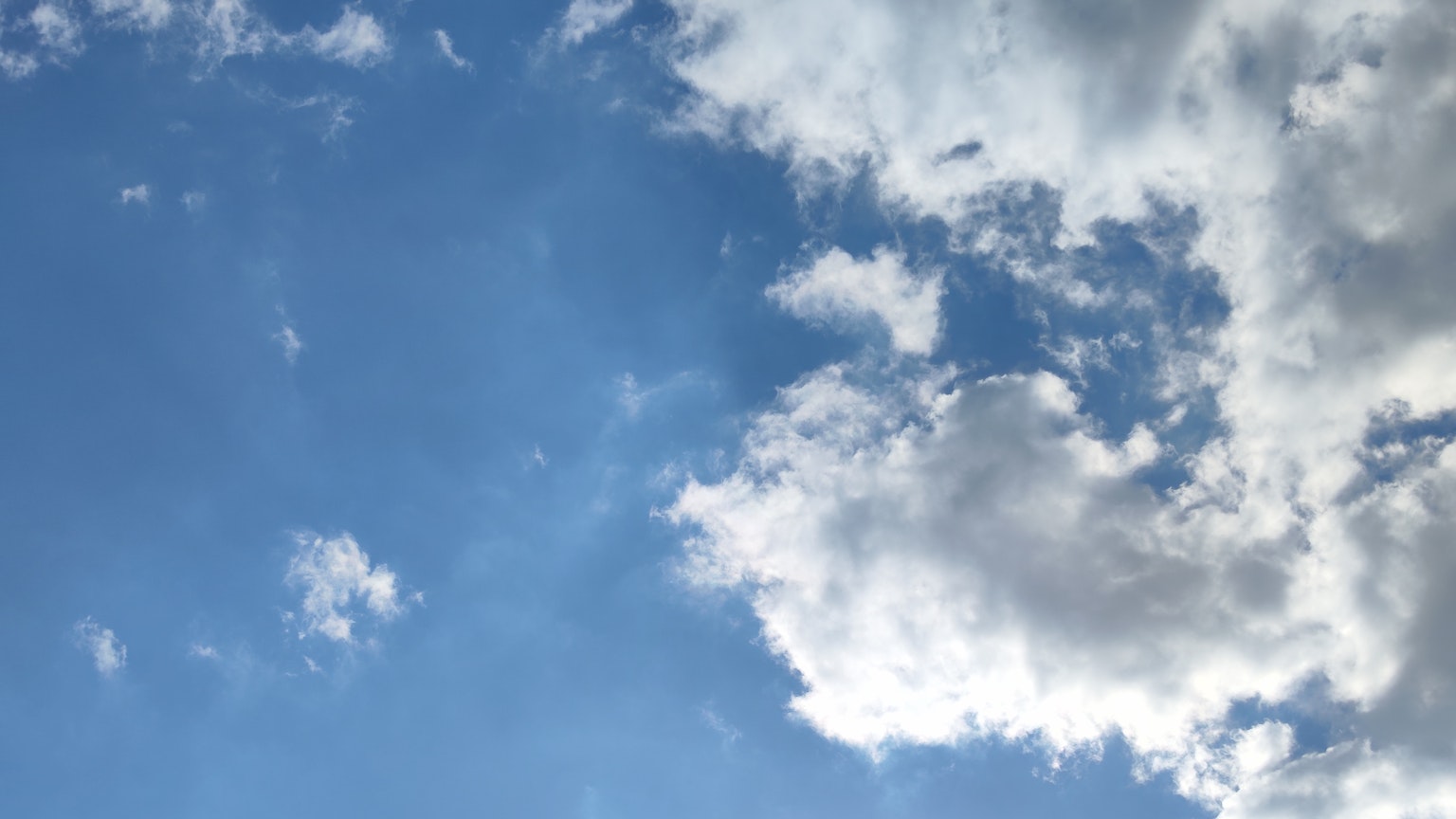 Heller blauer Himmel mit fluffigen weißen Wolken