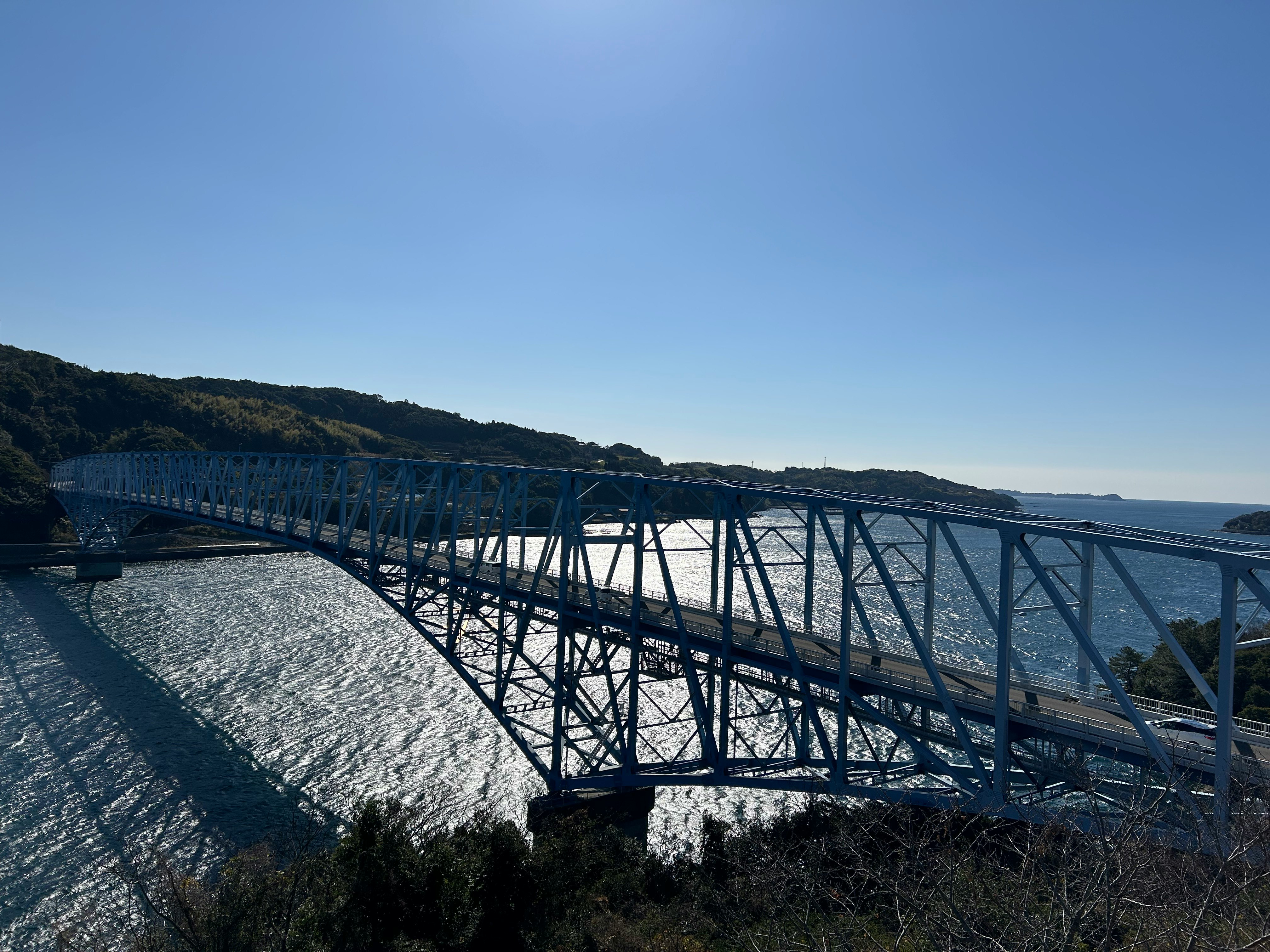long bridge along the coast under a blue sky