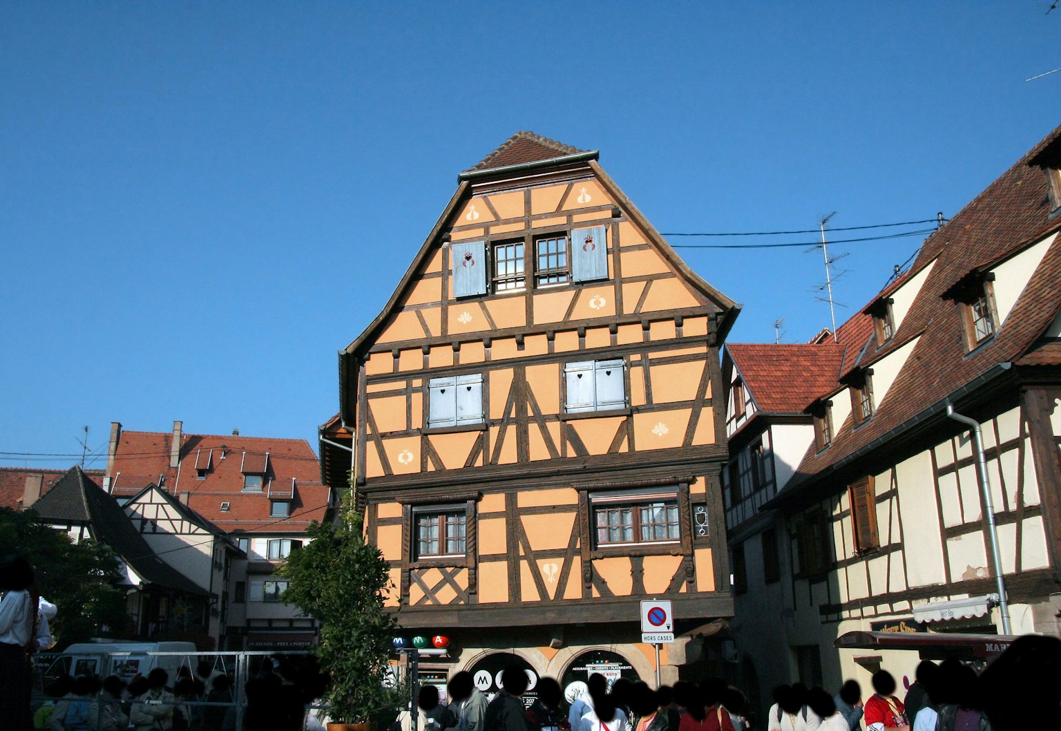 Scenic view of a half-timbered house in a square with a clear blue sky