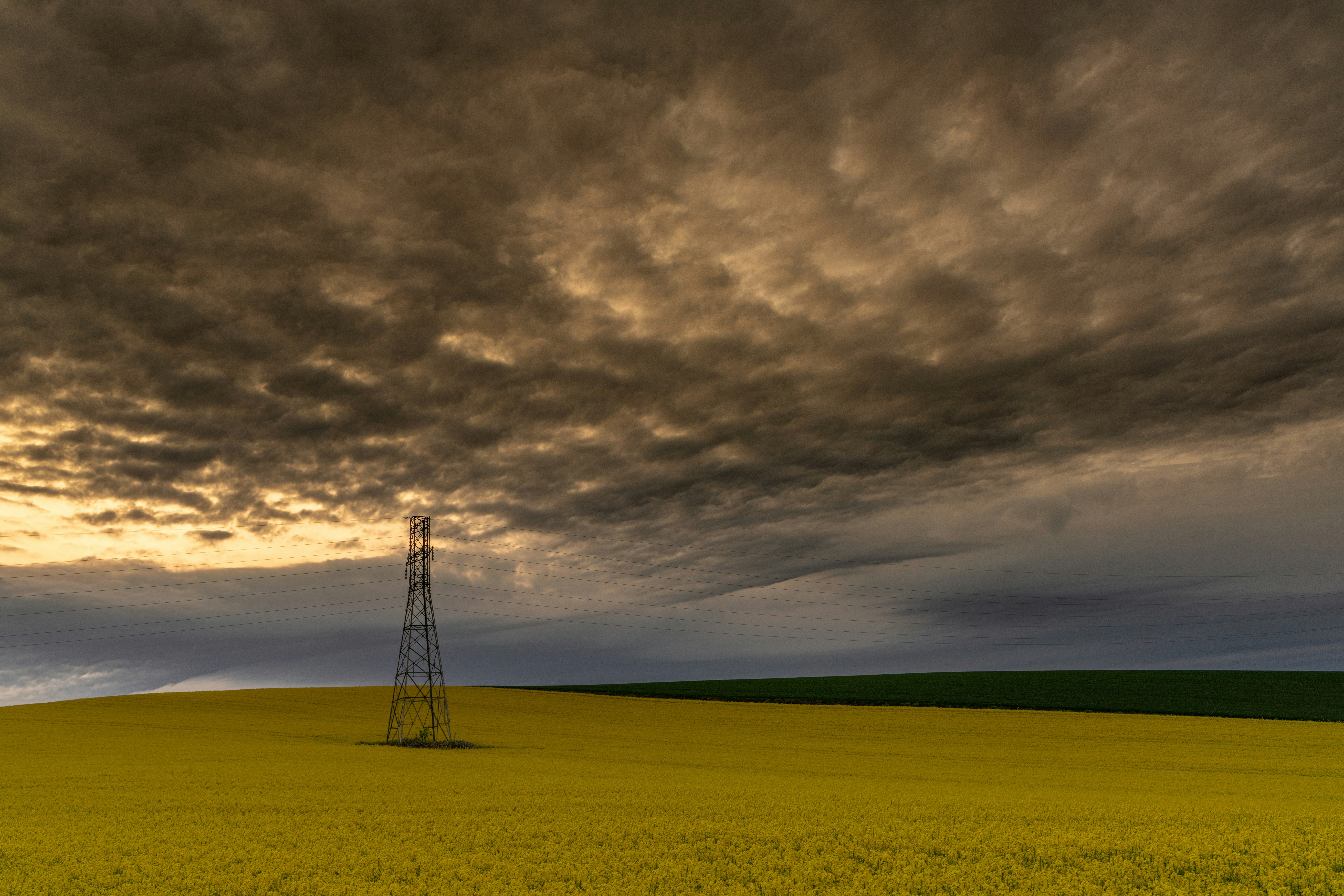 sunset clouds over a yellow hill landscape