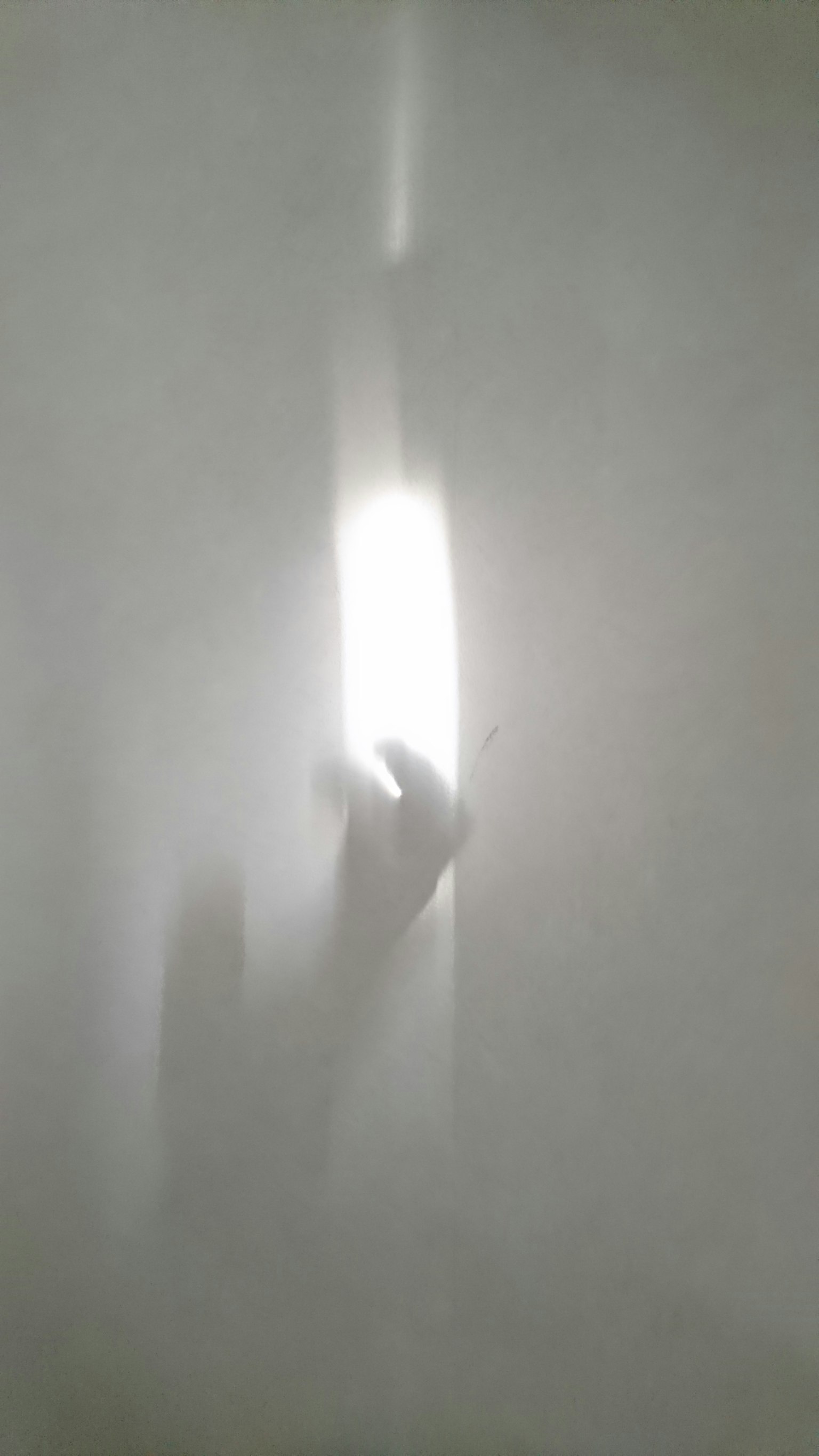 Abstract image featuring a hand shadow in light