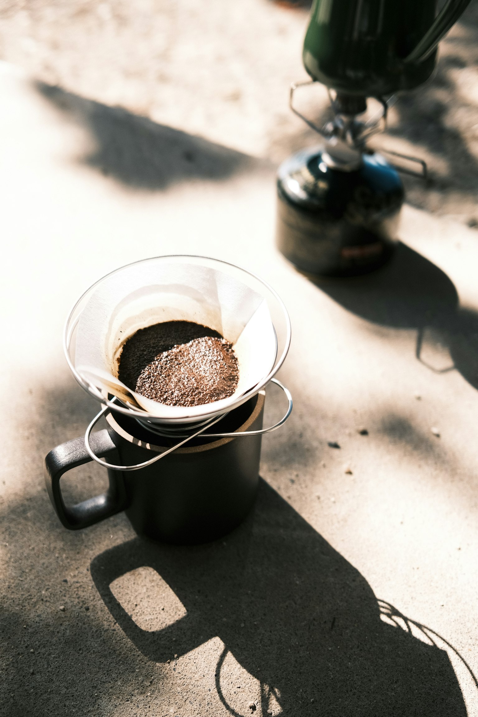 A scene with coffee brewing equipment featuring a black mug and coffee filter