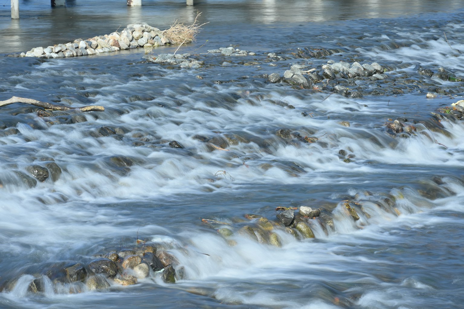 Flowing water over rocks with smooth ripples